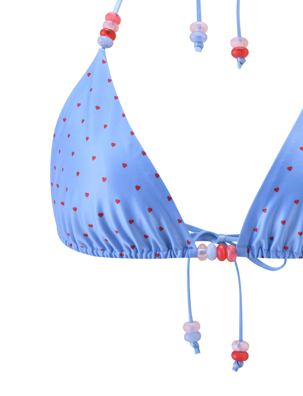 Close-up of the TIGERMIST FINLEA BIKINI TOP - BLUE HEART POLKA DOT, featuring a blue triangle design with heart polka dots and pink and red plastic beads on the halter neck straps and ties.