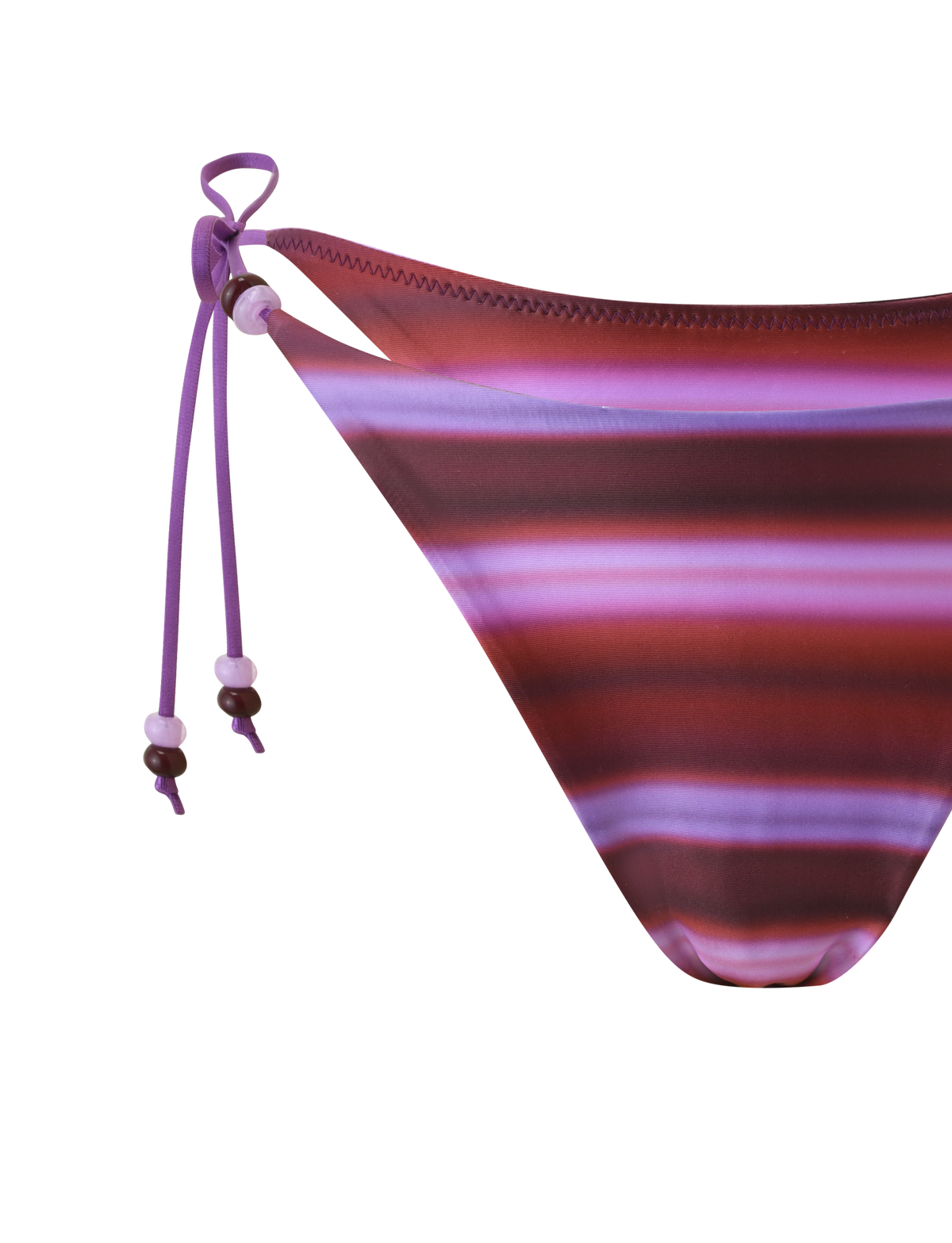 Close-up of the TIGERMIST FINLEA BIKINI BOTTOM - DUSK OMBRE STRIPE, featuring a cheeky cut, purple and pink horizontal stripes, and purple beaded side ties against a plain white background.