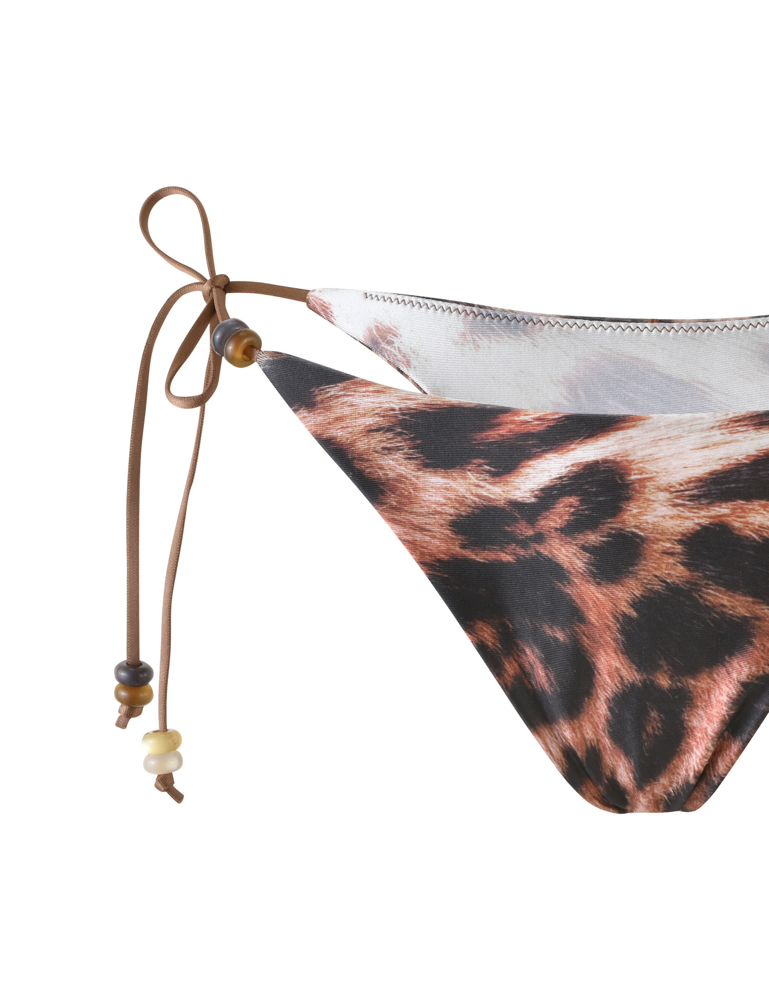 Close-up of the TIGERMIST FINLEA BIKINI BOTTOM in Leopard Haze, a neutral leopard print with a cheeky cut, brown tie strings, and decorative beads on the left side.