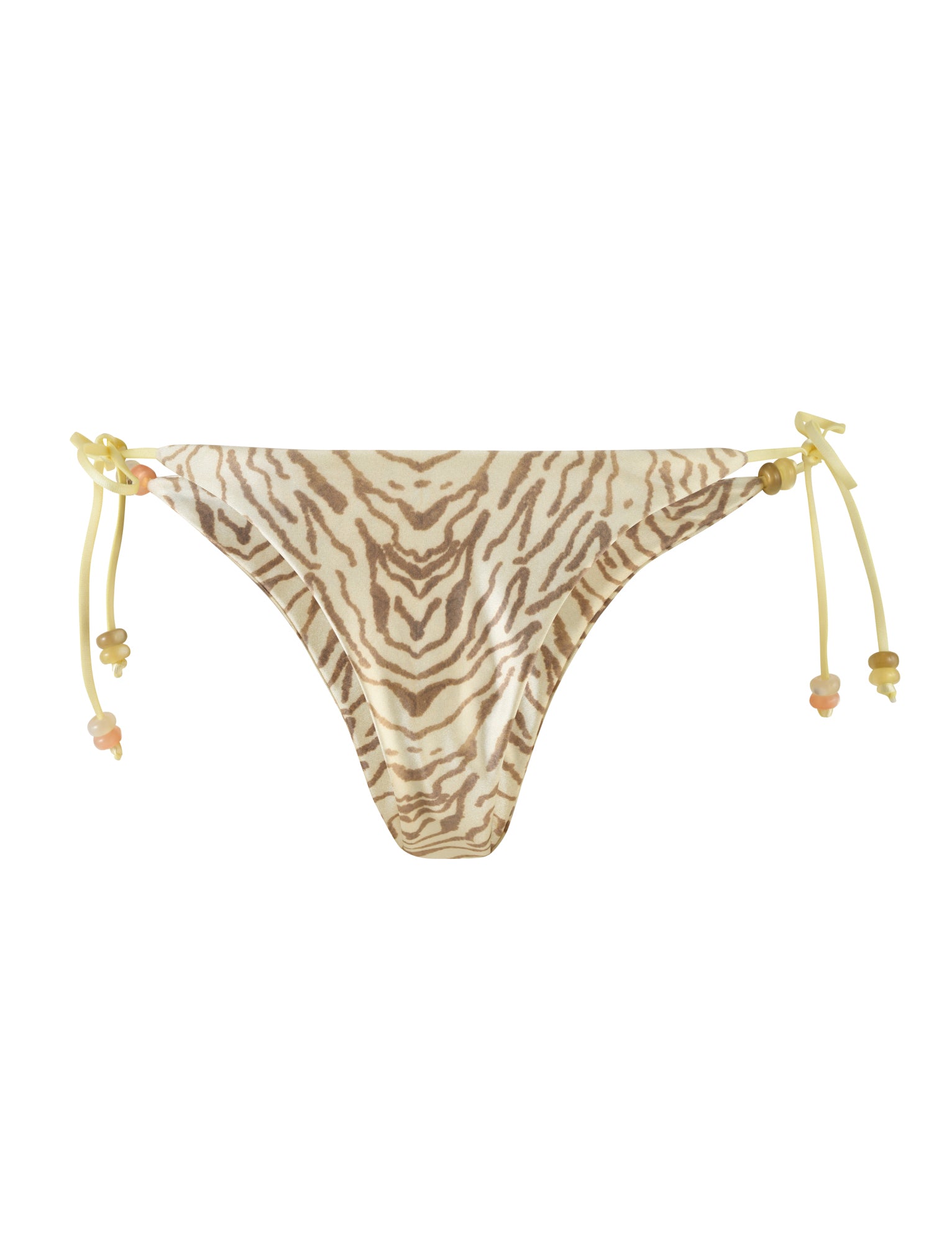 The FINLEA BIKINI BOTTOM - YELLOW : ZEBRA by TIGERMIST is a pair of bikini bottoms with a cheeky bikini cut and a yellow zebra print pattern in beige and brown tones. The swimsuit features high stretch fabric for comfort, along with yellow string ties on both sides, each adorned with small decorative beads.