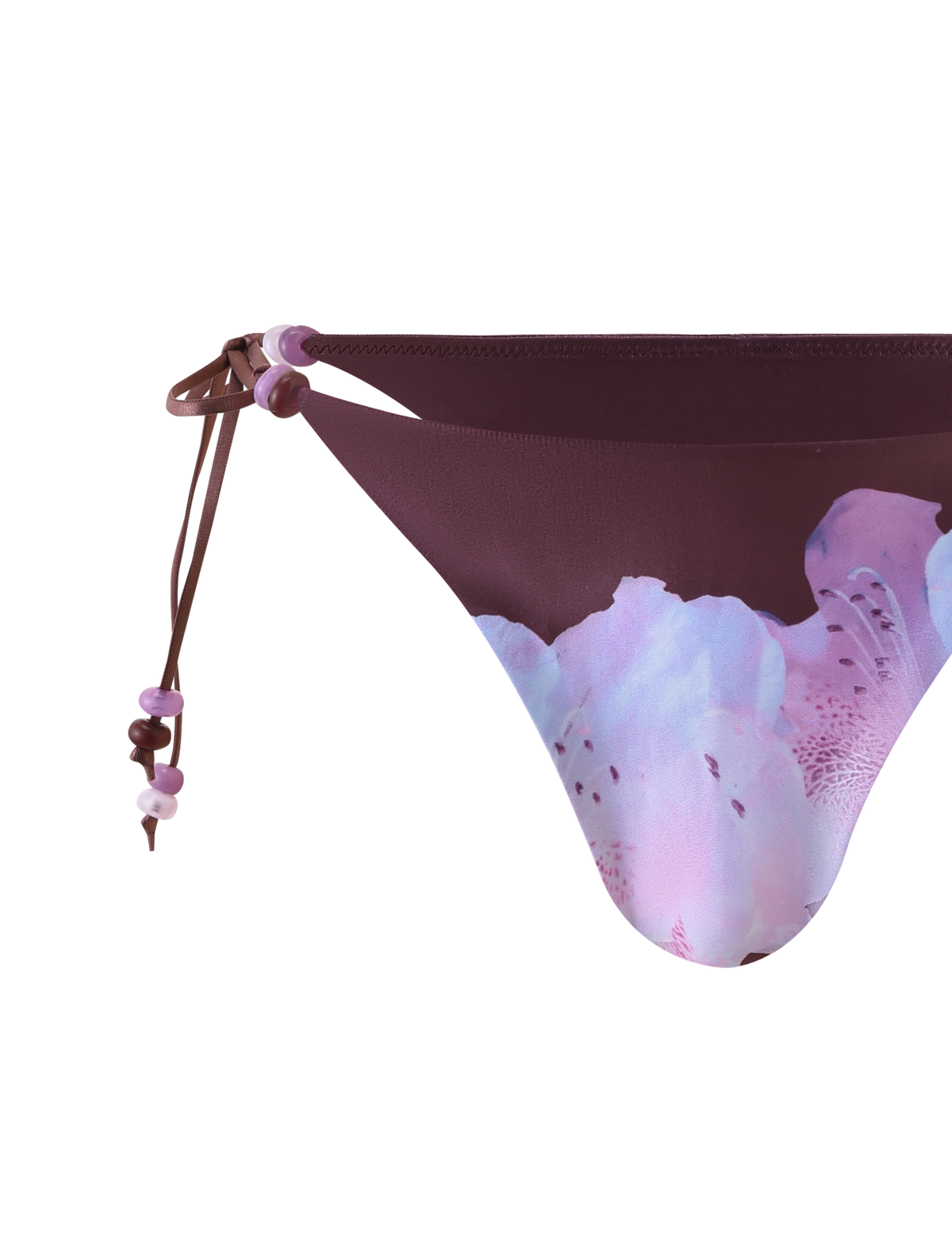 Close-up of FINLEA BIKINI BOTTOM - ZEN FLORAL by TIGERMIST, featuring a maroon waistband, beaded straps with pink and purple beads, and a light pink and lavender floral print on a white background.