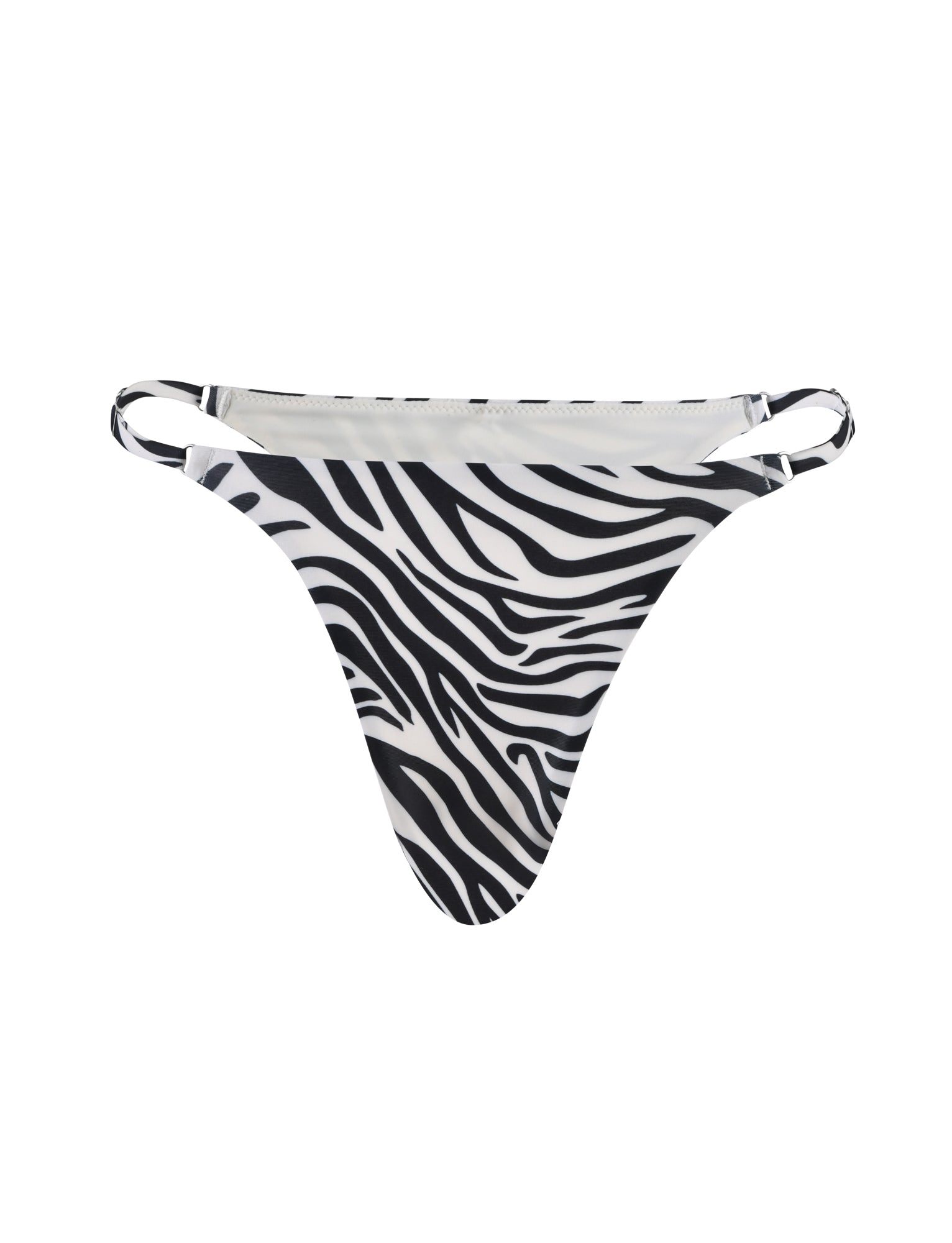 A pair of TIGERMIST's DIVINA black zebra bikini bottoms is displayed against a plain white background. The garment features thin side straps and a minimalistic design.