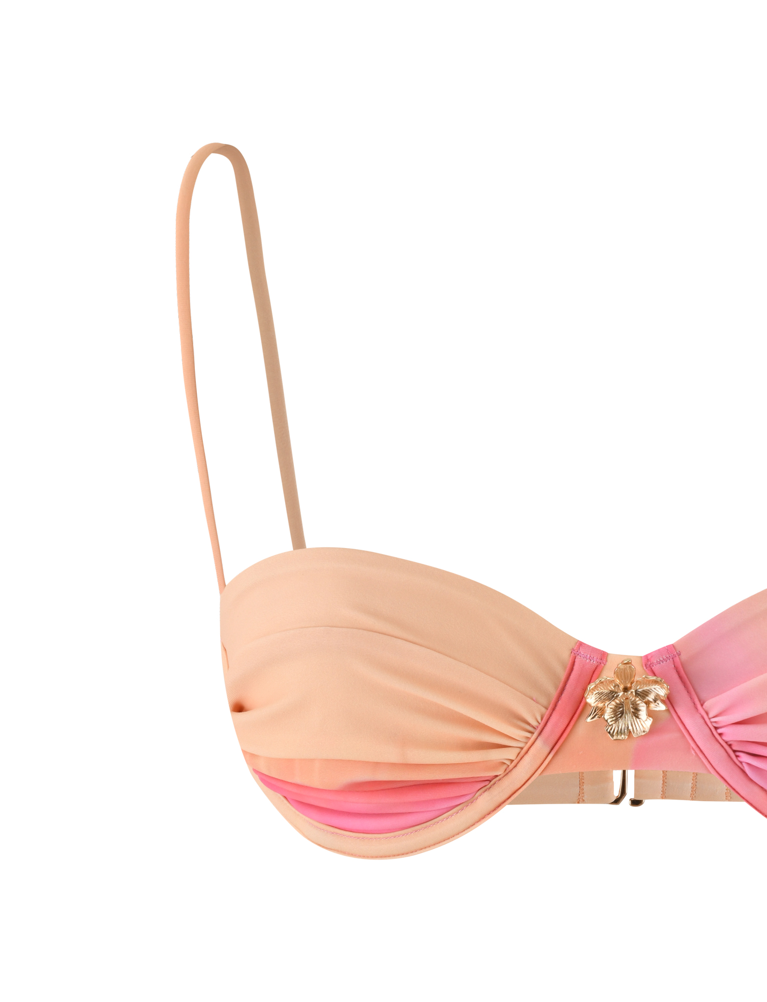 The KHESSA BIKINI TOP - PINK HIBISCUS by TIGERMIST features a gradient pink and orange design, a single thin adjustable shoulder strap, gold floral center embellishment, and ruched cup detailing.