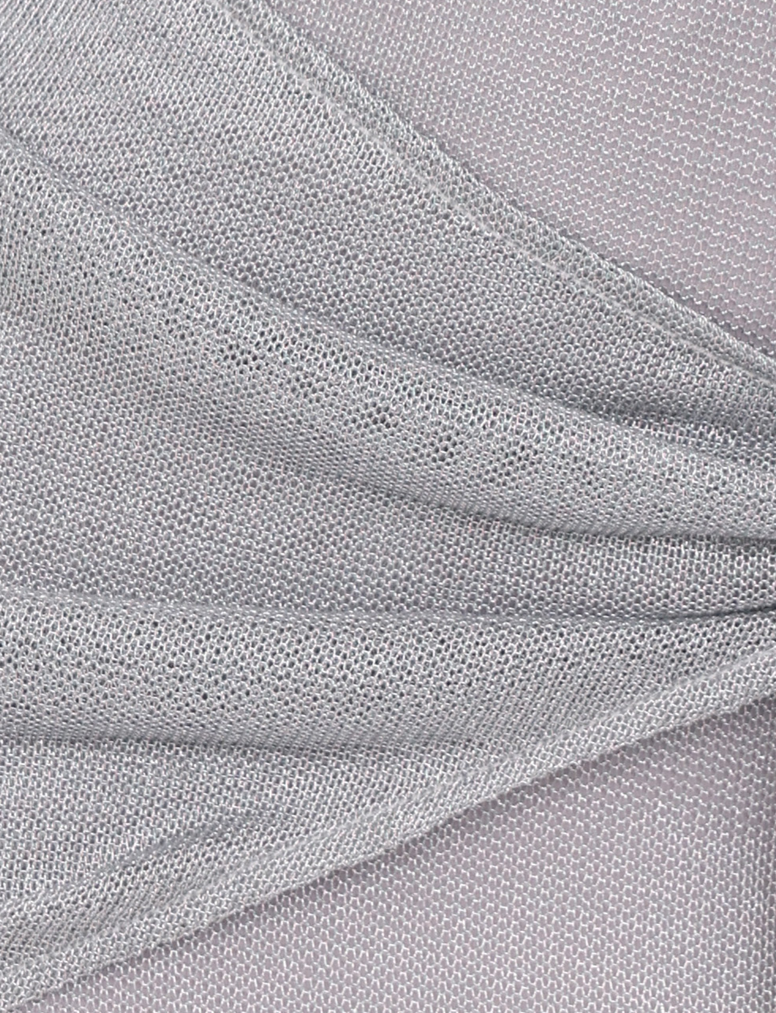 Close-up of the AZELMA DRESS - SILVER by TIGERMIST, showcasing its light gray knitted fabric with gathered, draped folds and an open weave pattern, evoking a sarong-style skirt for added texture and appeal.