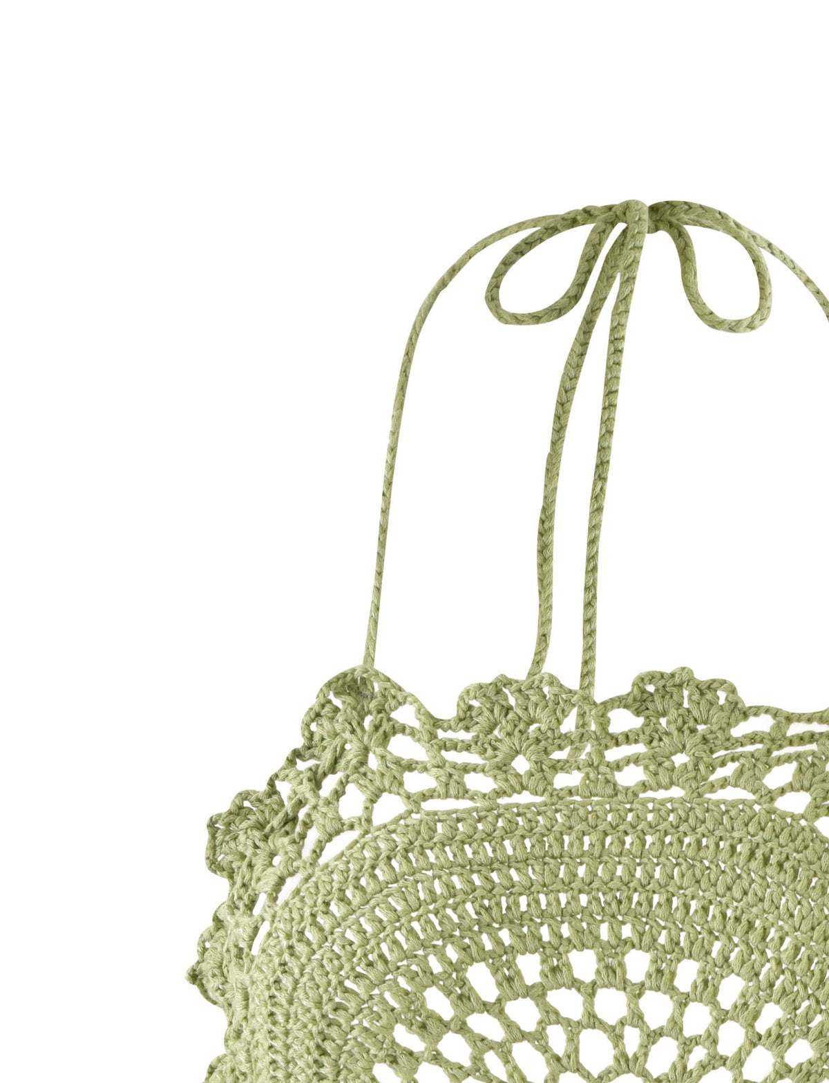 A close-up of the light green Maceline Dress from Tiger Mist showcases intricate crochet work with a circular pattern. The dress ties at the back of the neck with thin, crocheted strings and features a delicate scalloped edge. The background is plain white.