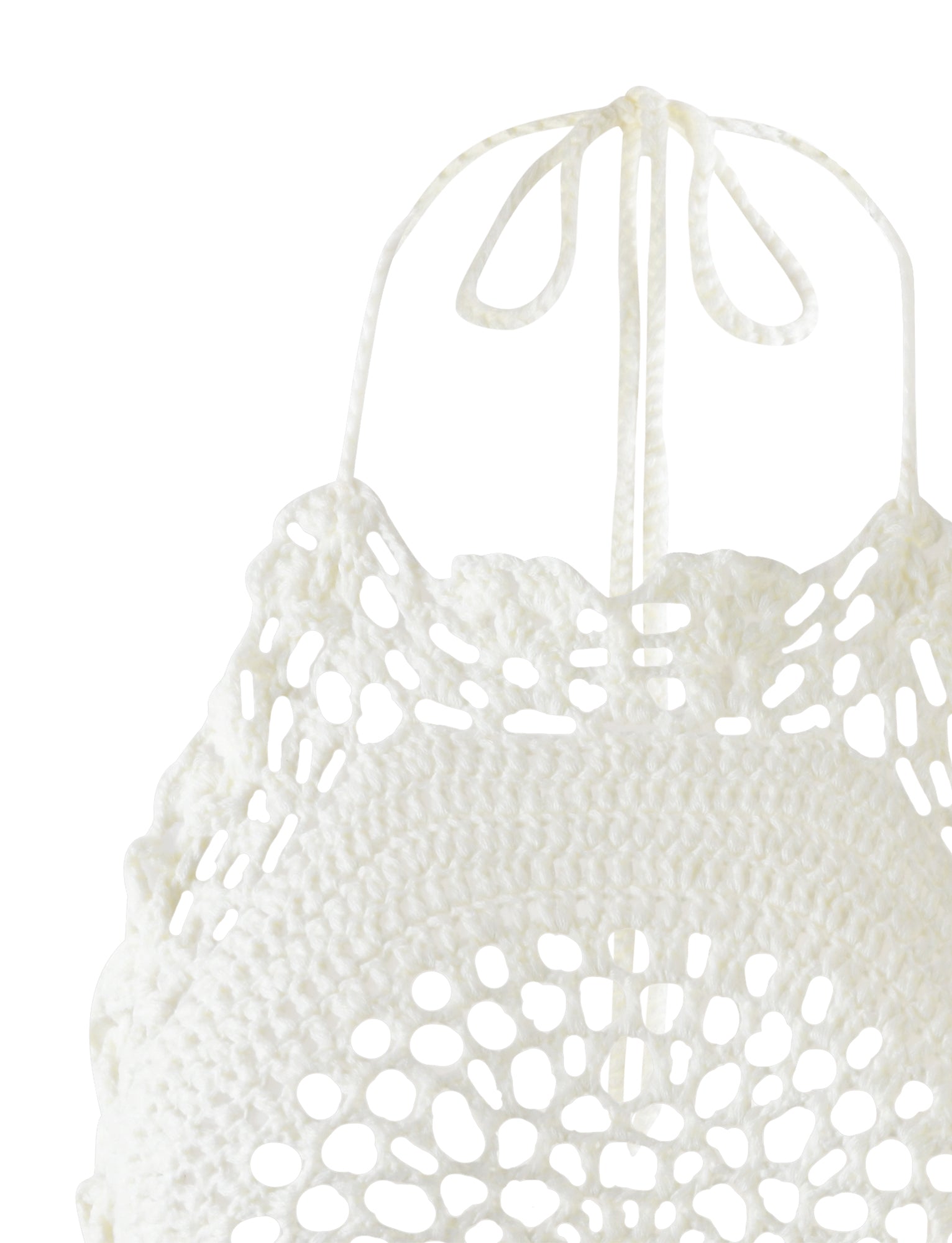 Close-up of the Maceline Dress in white from TIGERMIST. This dress features intricate crocheted patterns, showcasing an open floral-like motif crafted with delicate crochet threads, and it ties into a bow at the neck. The detailed and delicate crochet work highlights its exquisite craftsmanship.
