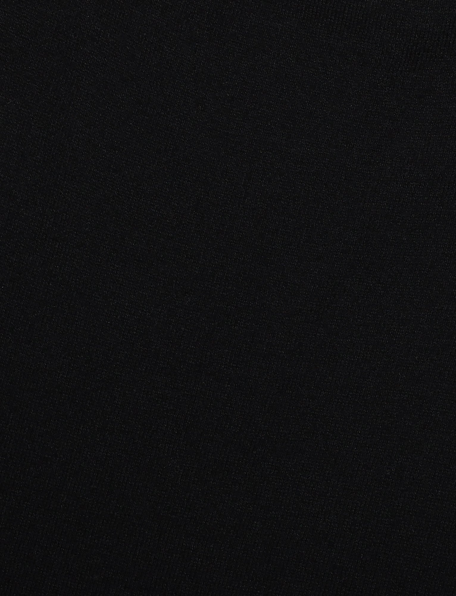 A solid black background with no visible patterns, textures, or objects. The image is completely dark and uniform, reminiscent of a blank canvas awaiting the elegance of the TIGERMIST Diedre Jumper Dress - Black with its fully fashioned knit and fitted silhouette.