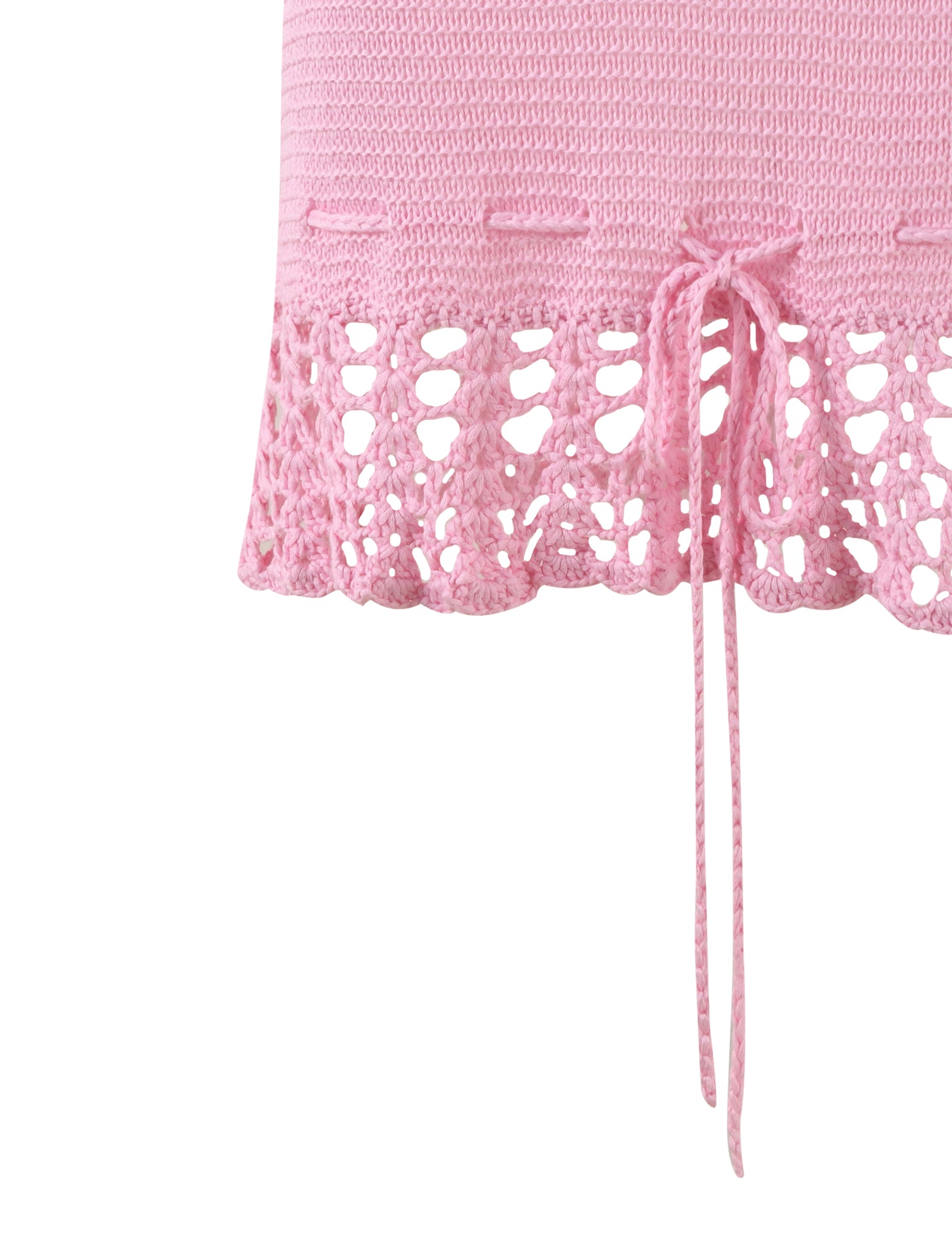 Close-up of the JULANE DRESS - PINK from TIGERMIST, featuring a drawstring tie at the waist. The bottom half of the dress showcases a lacy, open-knit pattern, providing an intricate and delicate texture.