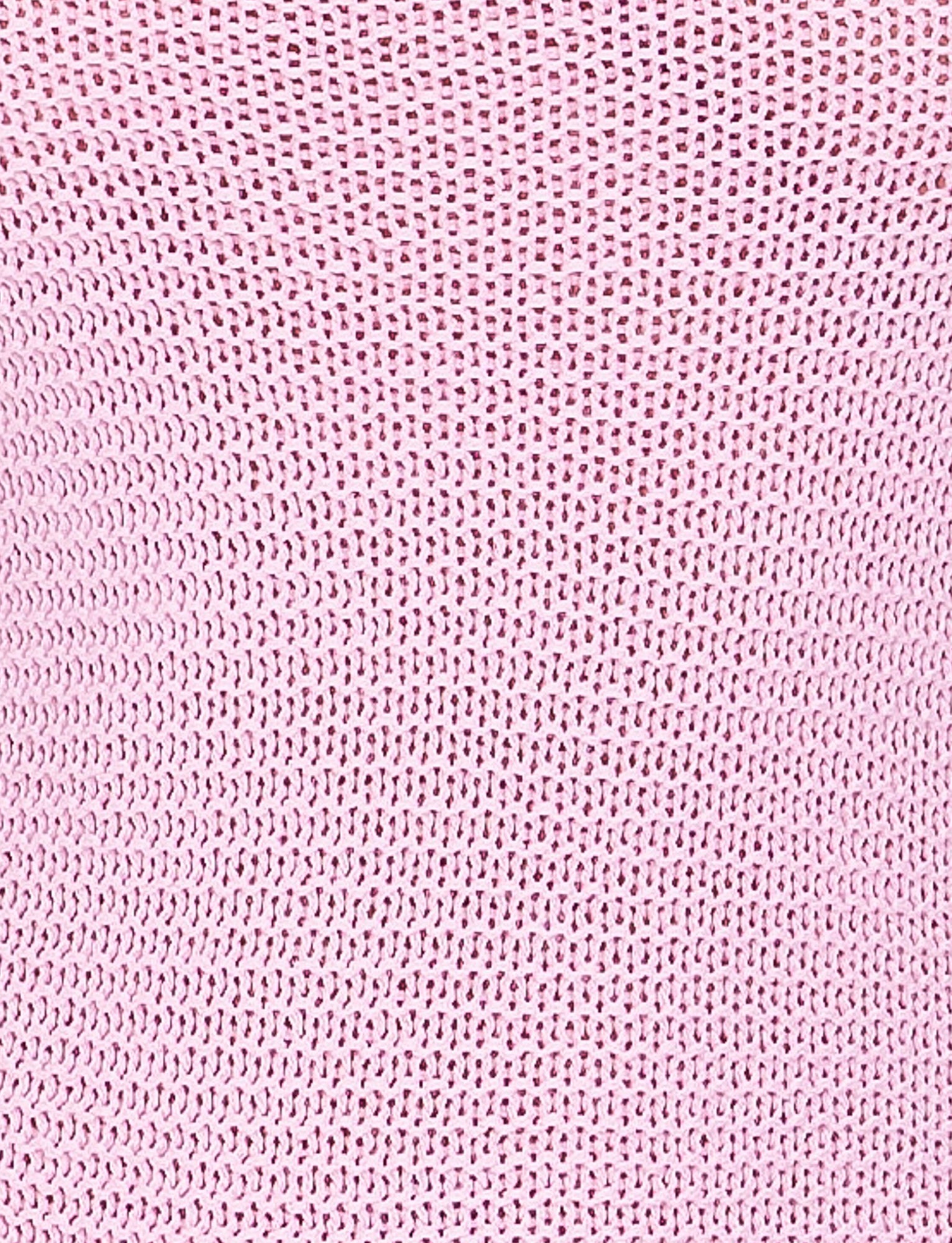 A close-up image of the pink textured woven fabric from the JULANE DRESS by TIGERMIST, showcasing a pattern of small, evenly spaced holes. The fabric appears soft and slightly stretchy, with a consistent knit design throughout.