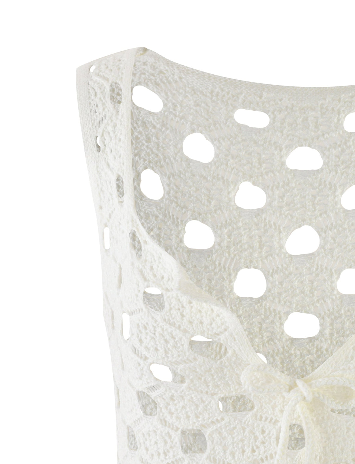 Close-up of the TIGERMIST KINCADE TOP - WHITE showcasing its open, airy crocheted pattern and circular cutouts. The light, textured material features a scallop-edged neckline and a tie detail at the center.