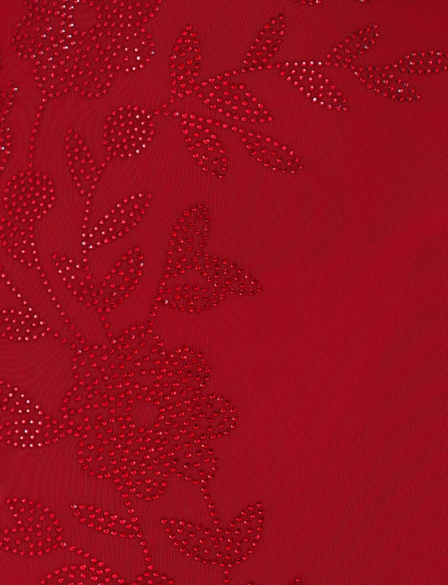 This close-up of a cherry red fabric highlights a detailed floral pattern consisting of small perforations, similar to the intricate embellishments found on the OCTAVIA MAXI DRESS by TIGERMIST. The design, featuring leaves and flowers, creates a textured appearance ideal for a maxi-length dress.
