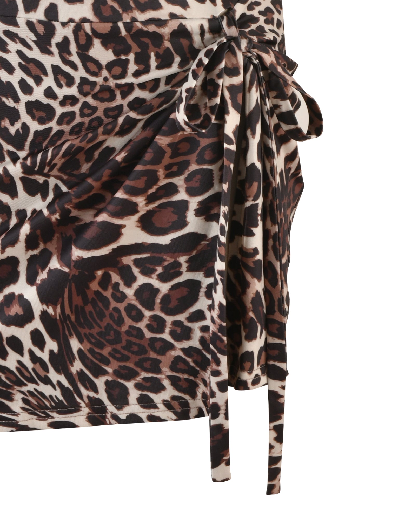A close-up view of the KADENCE DRESS - MULTI : LEOPARD from TIGERMIST reveals a striking leopard print pattern in shades of brown, black, and beige. The fabric is skillfully gathered and tied with a bow on the right side, creating an elegant ruched effect.