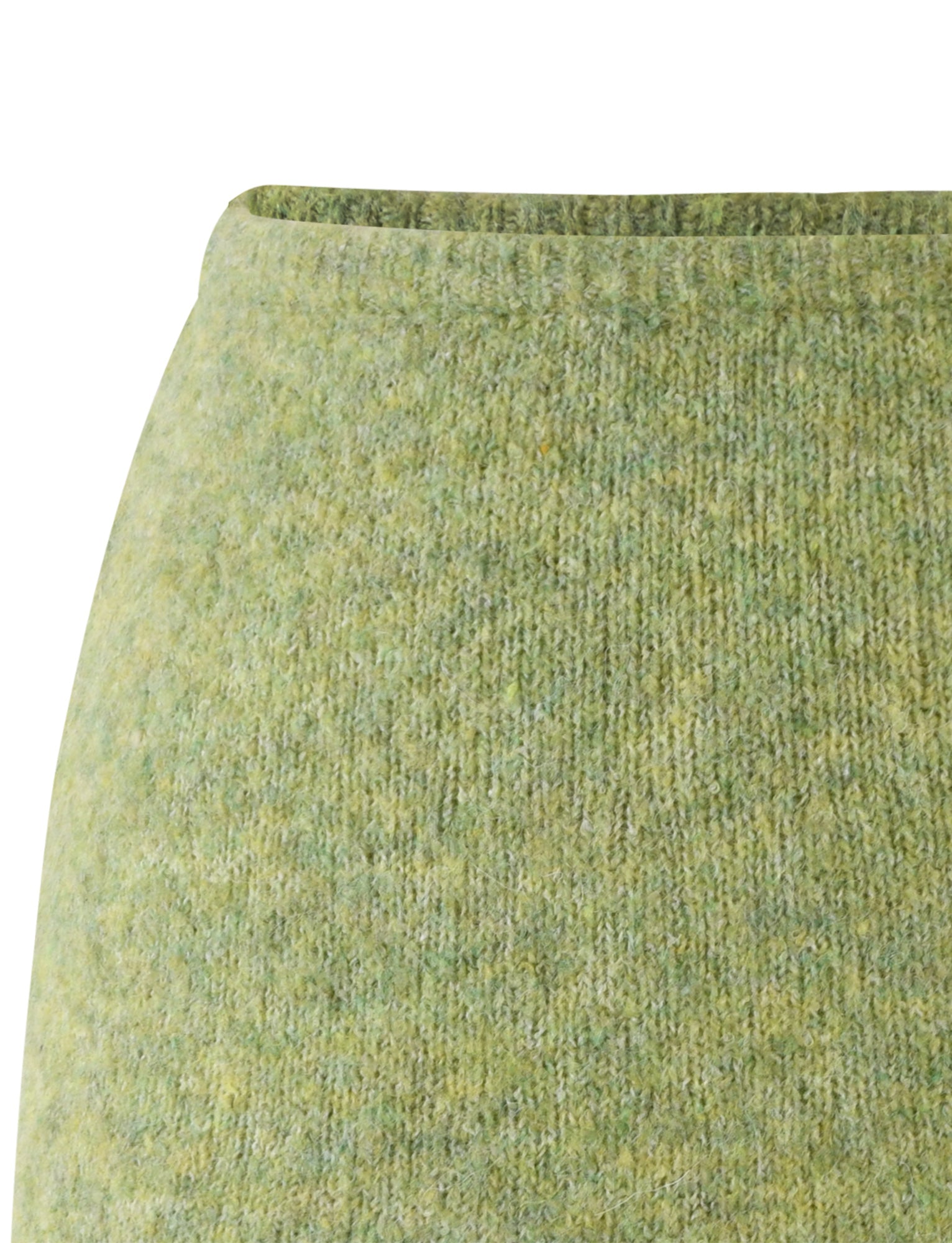 A close-up view of the LYRICA MINI SKIRT - GREEN from TIGERMIST reveals a green knitted fabric with a soft, slightly fuzzy texture. The thick knit features a mottled pattern with various shades of green, indicating its suitability for warm clothing or home textiles.