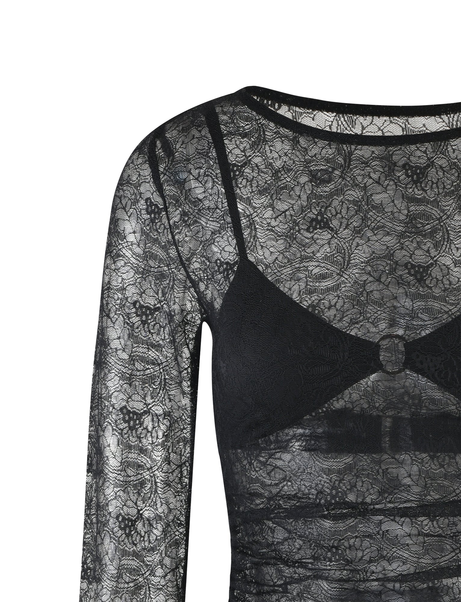 A long-sleeve, semi-transparent black lace top featuring an intricate floral pattern by TIGERMIST. The ALAYNA THREE PIECE MINI DRESS - BLACK includes a coordinating black bra with a round metal ring detail at the center.