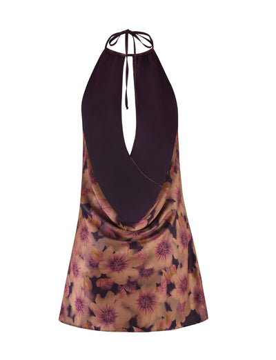 Introducing the Monroe Dress by Tigermist, a stylish dress with a halter neckline and a floral watercolor print that highlights pink and purple flowers set against a dark background. The dress offers a relaxed fit with an elegant keyhole front opening for added sophistication.