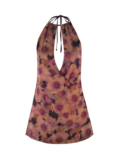 Discover the elegant MONROE DRESS by TIGERMIST, featuring a floral halter-neck design with a striking watercolor print. Large pink and purple flowers adorn the brown backdrop, while a deep V-neckline is elegantly accented by a delicate neck tie.