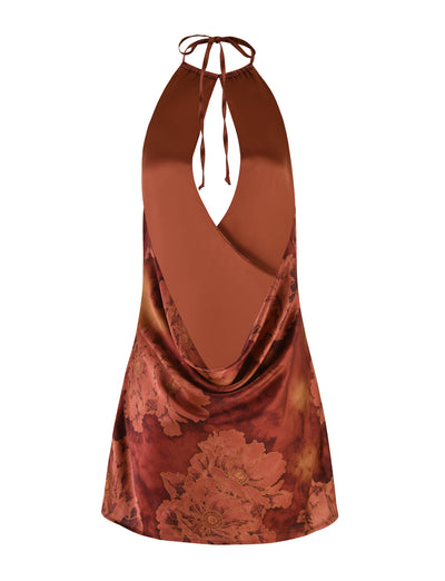 Introducing the TIGERMIST MONROE DRESS - RED : FLORAL : WATER COLOUR, a sleeveless and backless red halter mini dress featuring a deep V-neck and tie at the neck. This elegant dress boasts a rich floral print in shades of red and pink, crafted from smooth, slightly shiny fabric for an opulent finish.