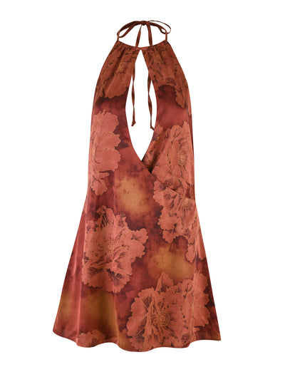 The MONROE DRESS - RED : FLORAL : WATER COLOUR by TIGERMIST is a sleeveless, halter-neck mini dress featuring a bold, large floral print in shades of red and orange. The red dress includes a tie at the neck and a keyhole cutout in the front, creating an elegant and stylish design.