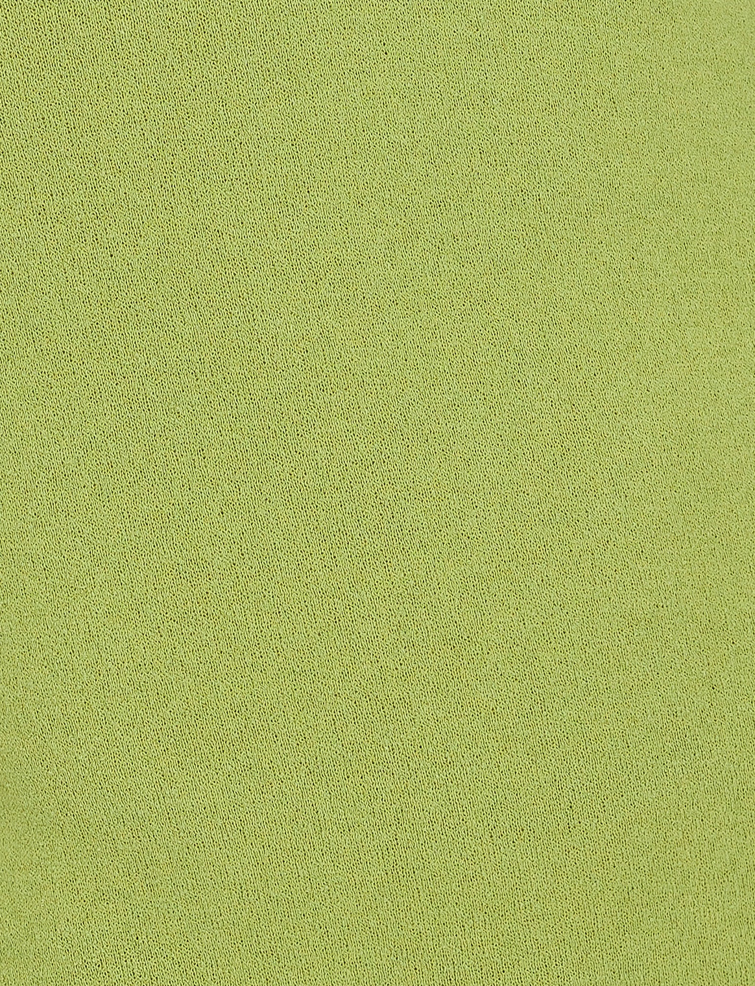 A close-up view of the TIGERMIST ROMIE DRESS in Matcha Green shows its solid light green color with a slightly textured, knit surface featuring a uniform pattern throughout.