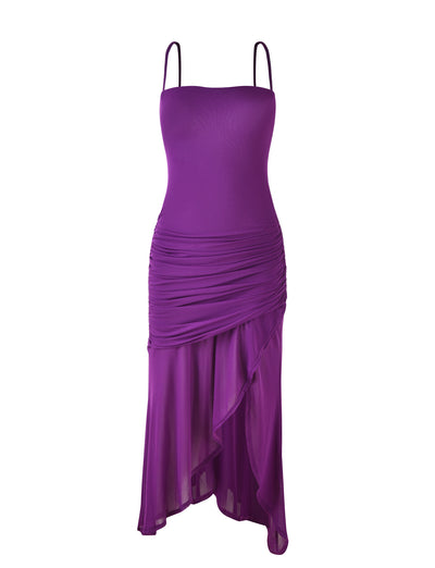 The COVE DRESS - PURPLE by TIGERMIST is a vibrant purple piece with spaghetti straps, featuring a fitted bodice and ruched design that wraps diagonally from the hip. This creates an asymmetrical hemline cascading down in soft, flowing layers, while the fabric has a subtle sheen.