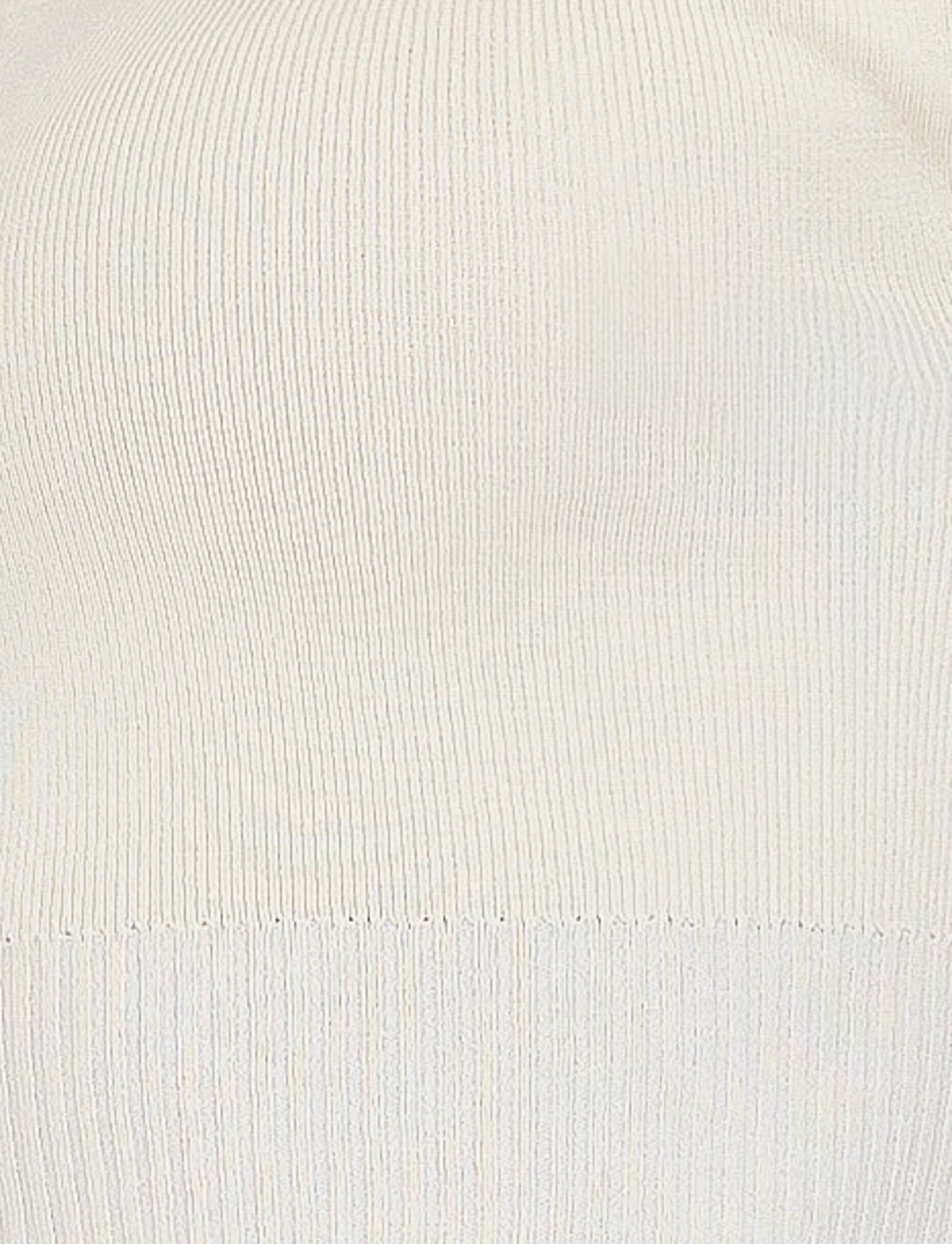Close-up of a cream-colored, ribbed fabric. The texture features fine vertical ribbing, creating a soft and consistent pattern. The fabric is smooth and lightweight, suggesting it might be part of TIGERMIST's LEDGER TOP in WHITE: CREAM.