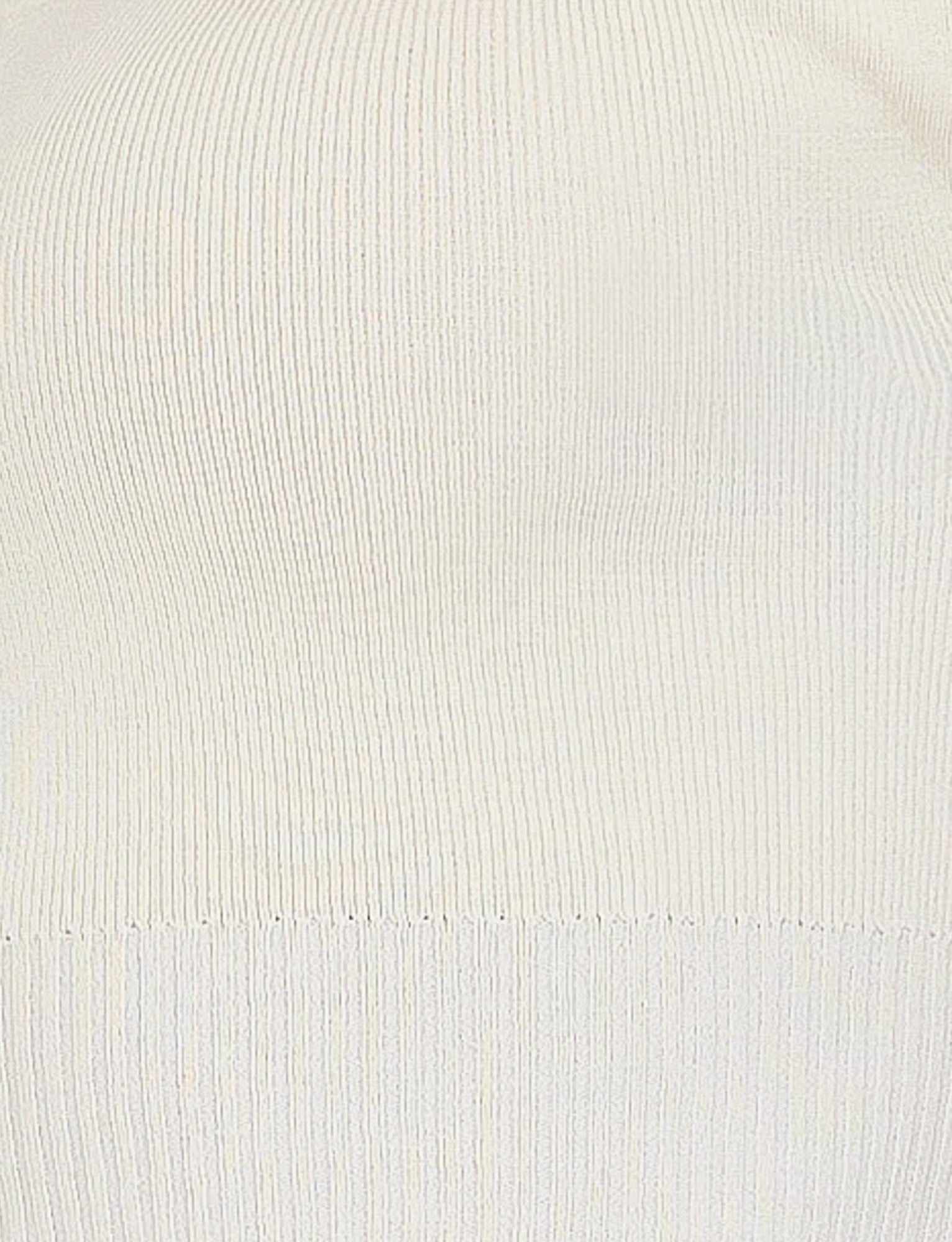 Close-up image of a white ribbed knit fabric, reminiscent of TIGERMIST's LEDGER SKIRT - WHITE : CREAM. The texture is uniform, showcasing vertical lines and a stretchy quality, typical of knitted garments. The lighting is even, highlighting the fabric's structure and detail.