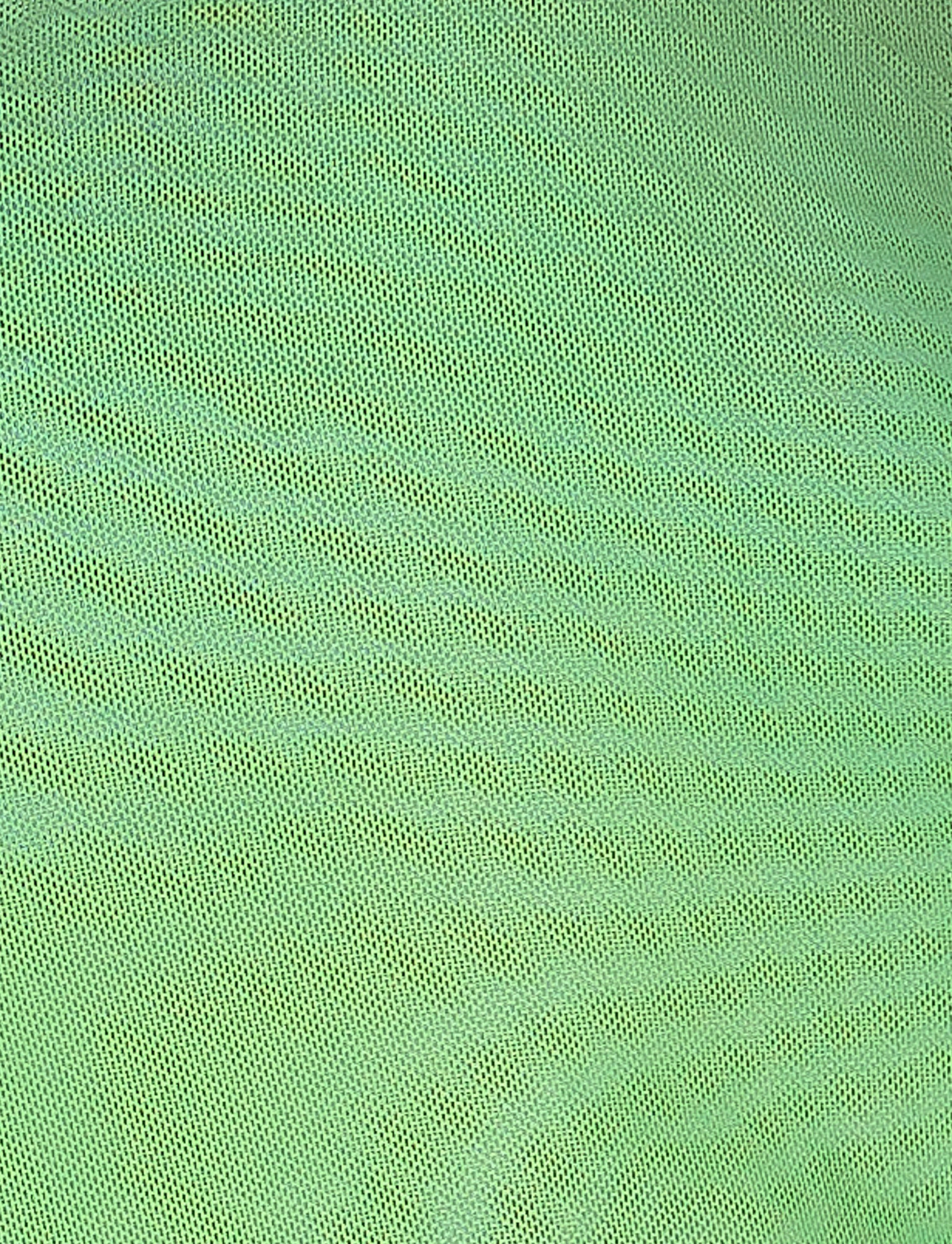 The NOELY TOP - MULTI : OMBRE : GRADIENT STRIPE from TIGERMIST features a green mesh fabric with a fine, uniform pattern akin to classic Tiger Mist designs. Its consistent texture appears delicate and reveals a subtle gradient of green shades based on lighting. The fabric's tightly knit weave creates small, regular openings across the surface.