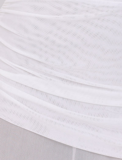 A close-up view of the ESHA MAXI DRESS - WHITE by TIGERMIST reveals a transparent fabric with layered, ruched detailing that echoes its bodycon silhouette. The textured appearance gently enhances the maxi length as light softly diffuses through the delicate material.