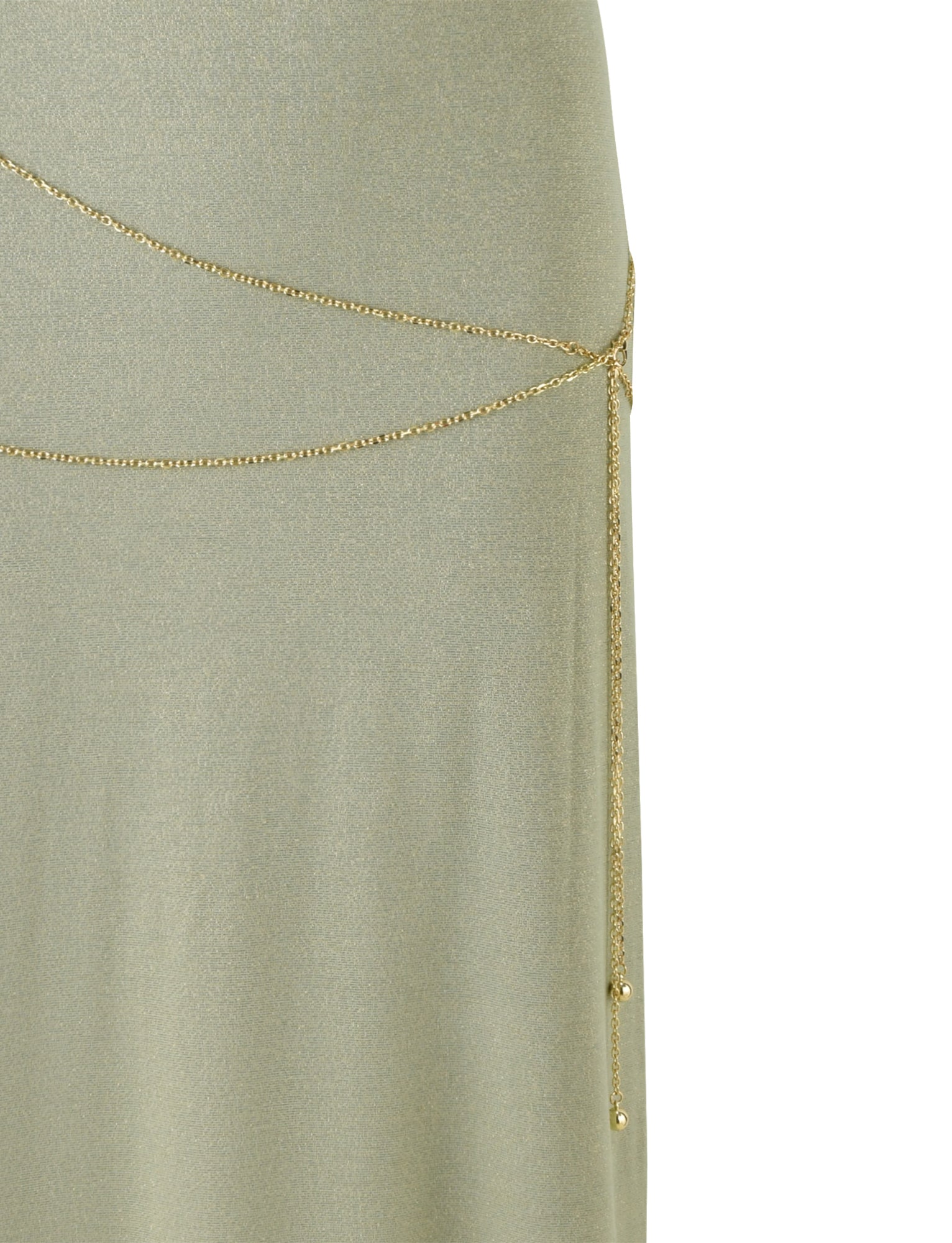 A close-up of TIGERMIST's OPELI MAXI DRESS - GREEN SPARKLE shows a light green, shimmery dress with a thin gold chain belt draped asymmetrically around the waist, secured by a small clasp on the right side. The chain adds an elegant touch and subtle decoration to the simple maxi-length design.