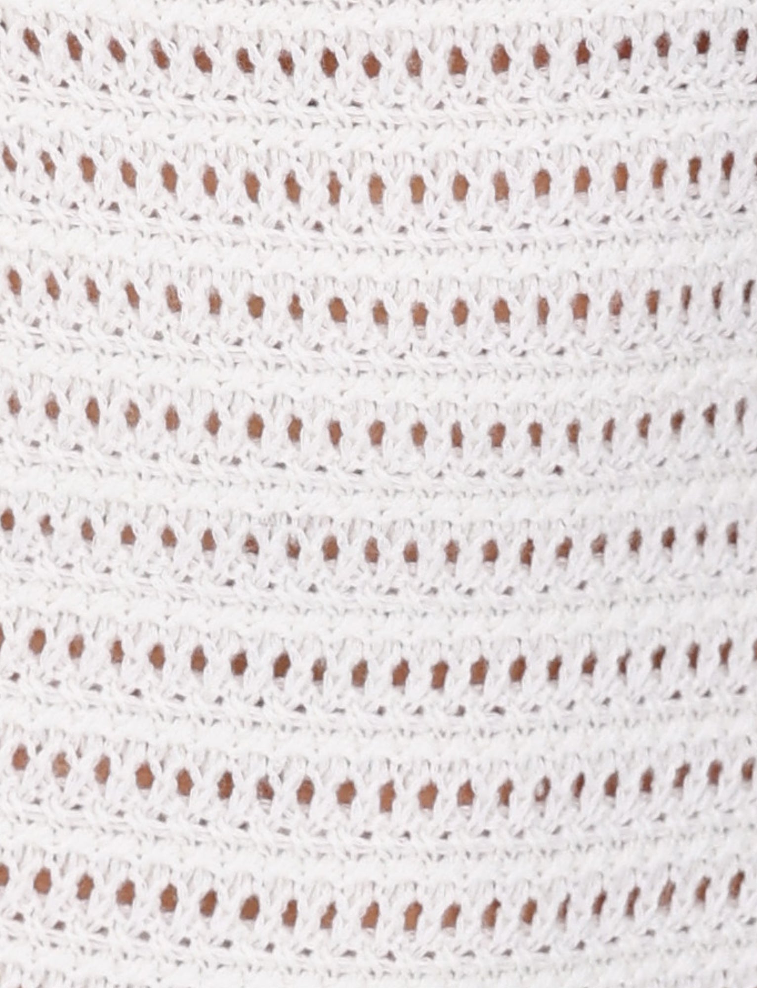 Close-up of the TIGERMIST MARLEIGH DRESS - WHITE featuring rows of evenly spaced, small oval holes. The texture and intricacy of the stitches are clearly visible, highlighting the delicate and detailed craftsmanship typical of a maxi length dress.