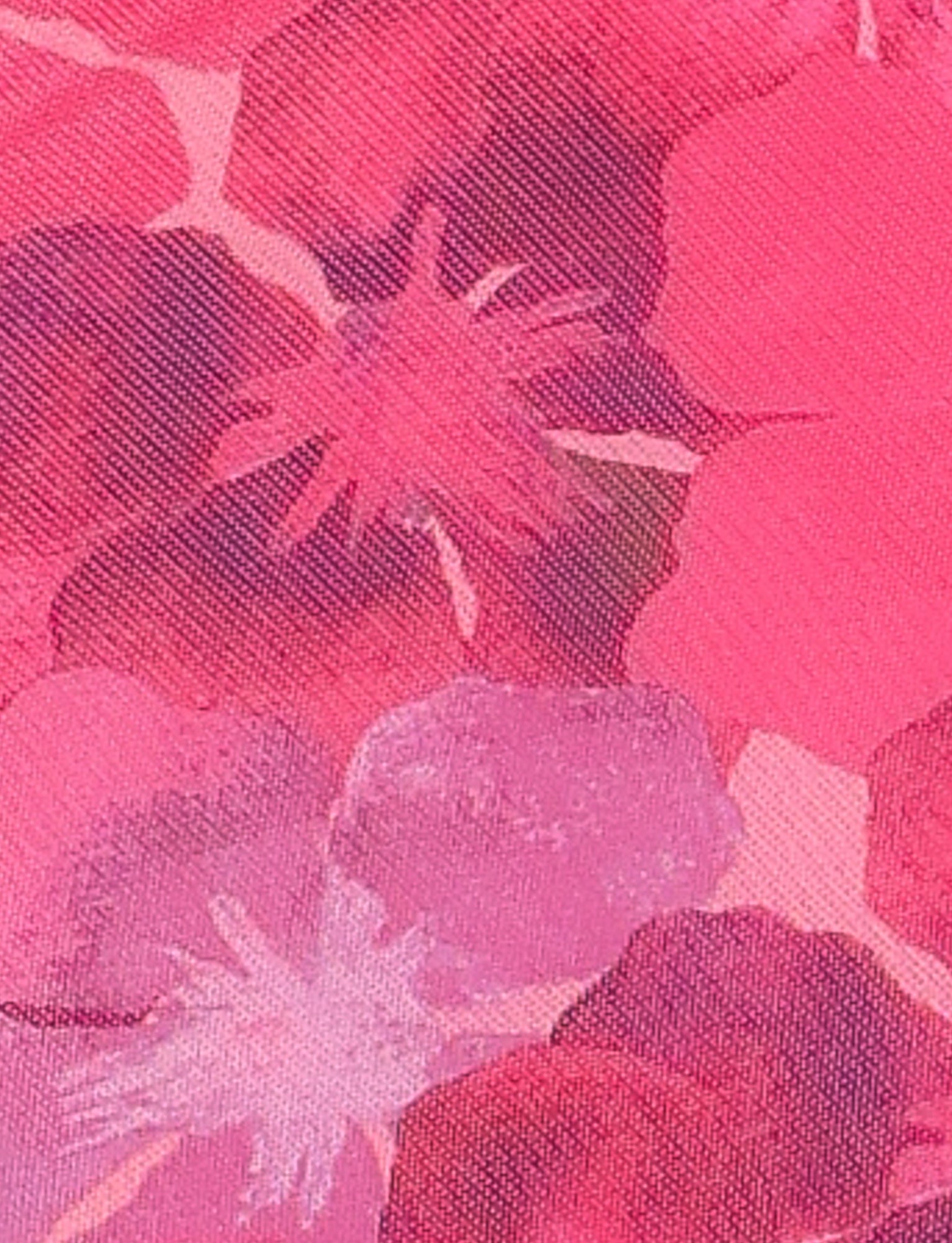 A close-up view of TIGERMIST's KRUZE MINI DRESS - PINK: HIBISCUS, showcasing its vibrant pattern in various shades of pink, red, and purple. The design features abstract flower shapes and a textured surface, all enhanced by the high stretch fabric that ensures a comfortable bodycon fit.
