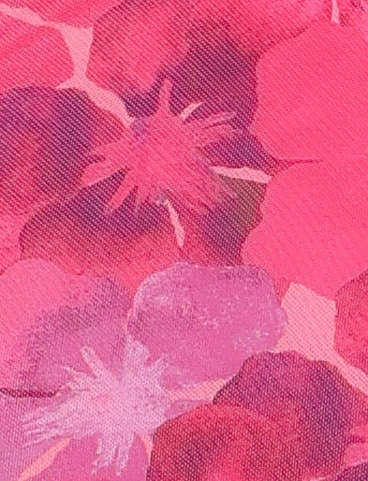 A close-up view of TIGERMIST's KRUZE MINI DRESS - PINK: HIBISCUS, showcasing its vibrant pattern in various shades of pink, red, and purple. The design features abstract flower shapes and a textured surface, all enhanced by the high stretch fabric that ensures a comfortable bodycon fit.