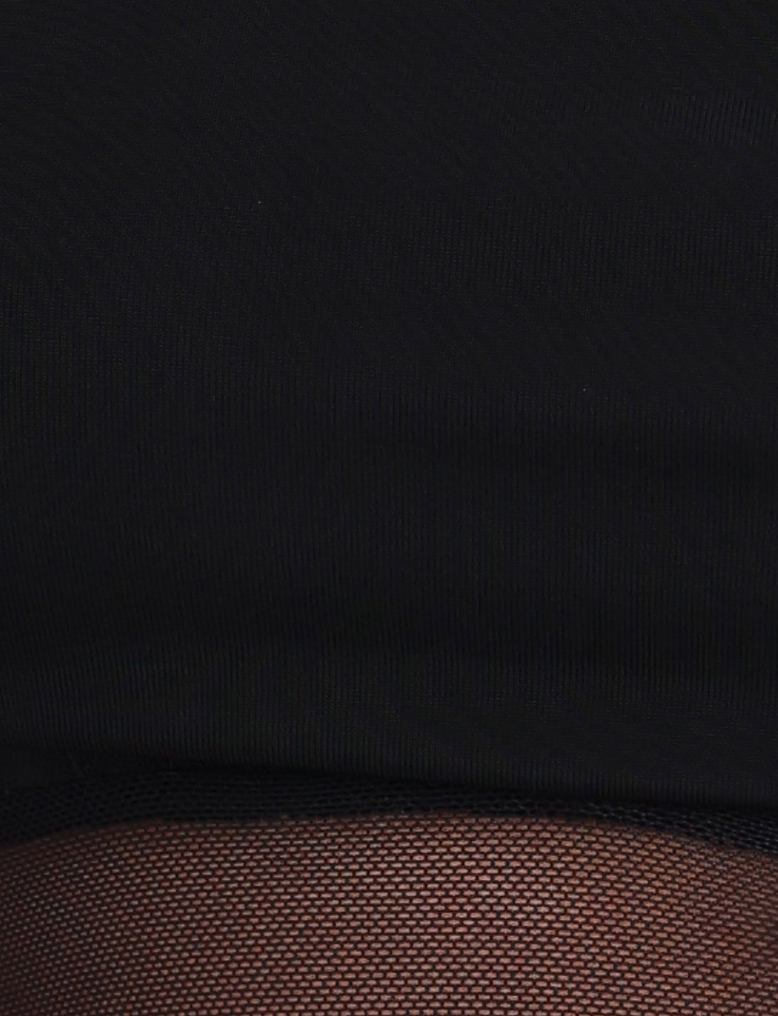 Close-up image showing the EMBERLAIN DRESS - BLACK by TIGERMIST, featuring textured black fabric transitioning to a dark brown, finely patterned section at the bottom. The textures and colors of this maxi-length dress create a striking contrast between the smooth black and the woven brown areas.