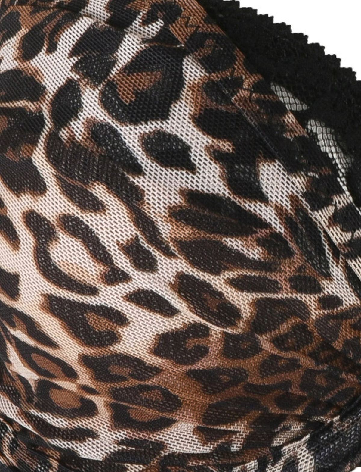 Close-up of the ALANIS SET - NEUTRAL : LEOPARD by TIGERMIST, featuring a leopard print fabric with black lace detailing at the edge. This bra and g-string set boasts dark brown and black spots on a light brown background, complemented by adjustable shoulder straps for a perfect fit.