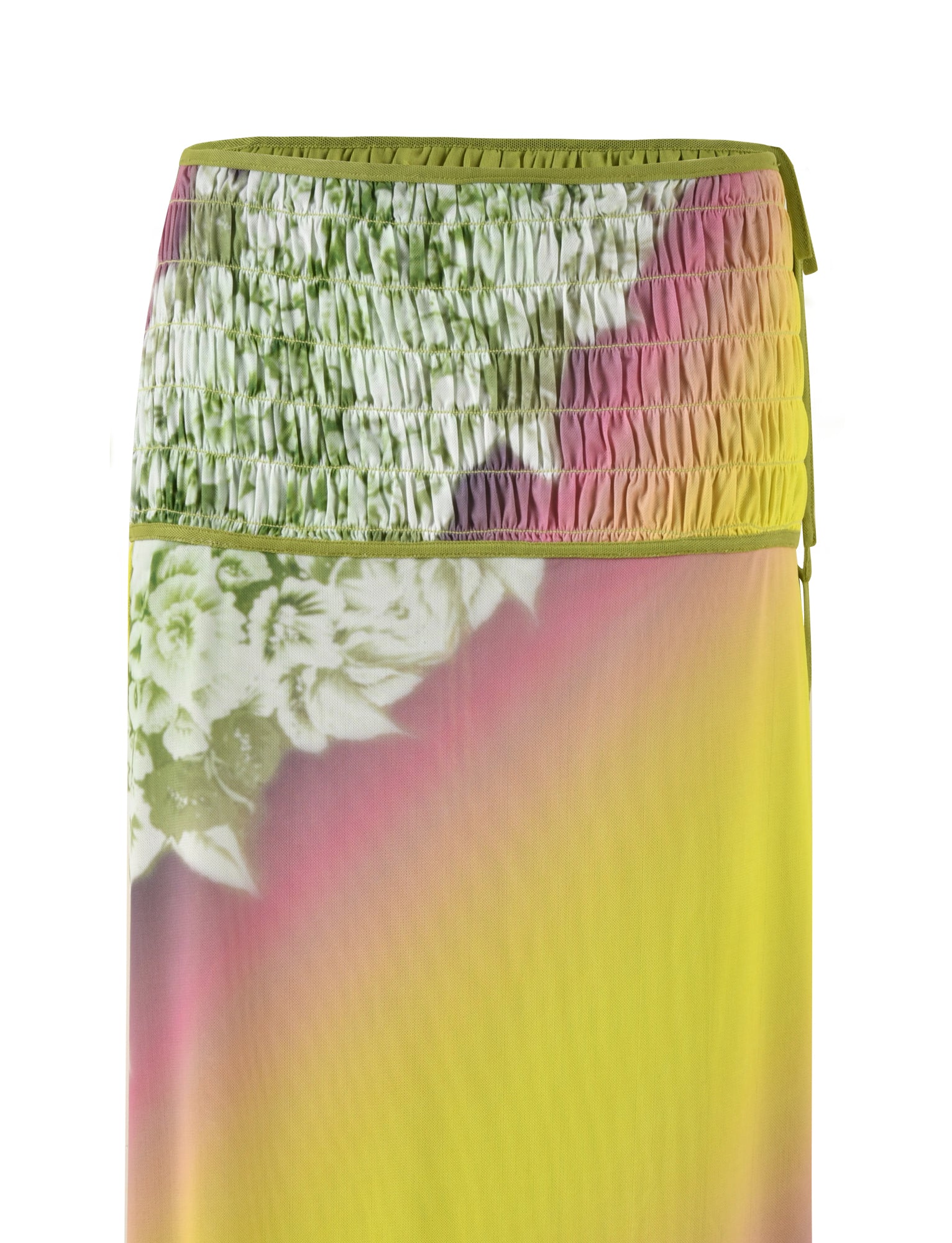 A close-up of the TIGERMIST WAVERLY SKIRT - GREEN: FLORAL: STRIPE reveals its colorful fabric with smocked details at the top. The skirt, possibly reversible, showcases a gradient of green, pink, and yellow with a white floral pattern near the upper section. The lightweight and flowy mesh fabric adds texture to the elegant design.