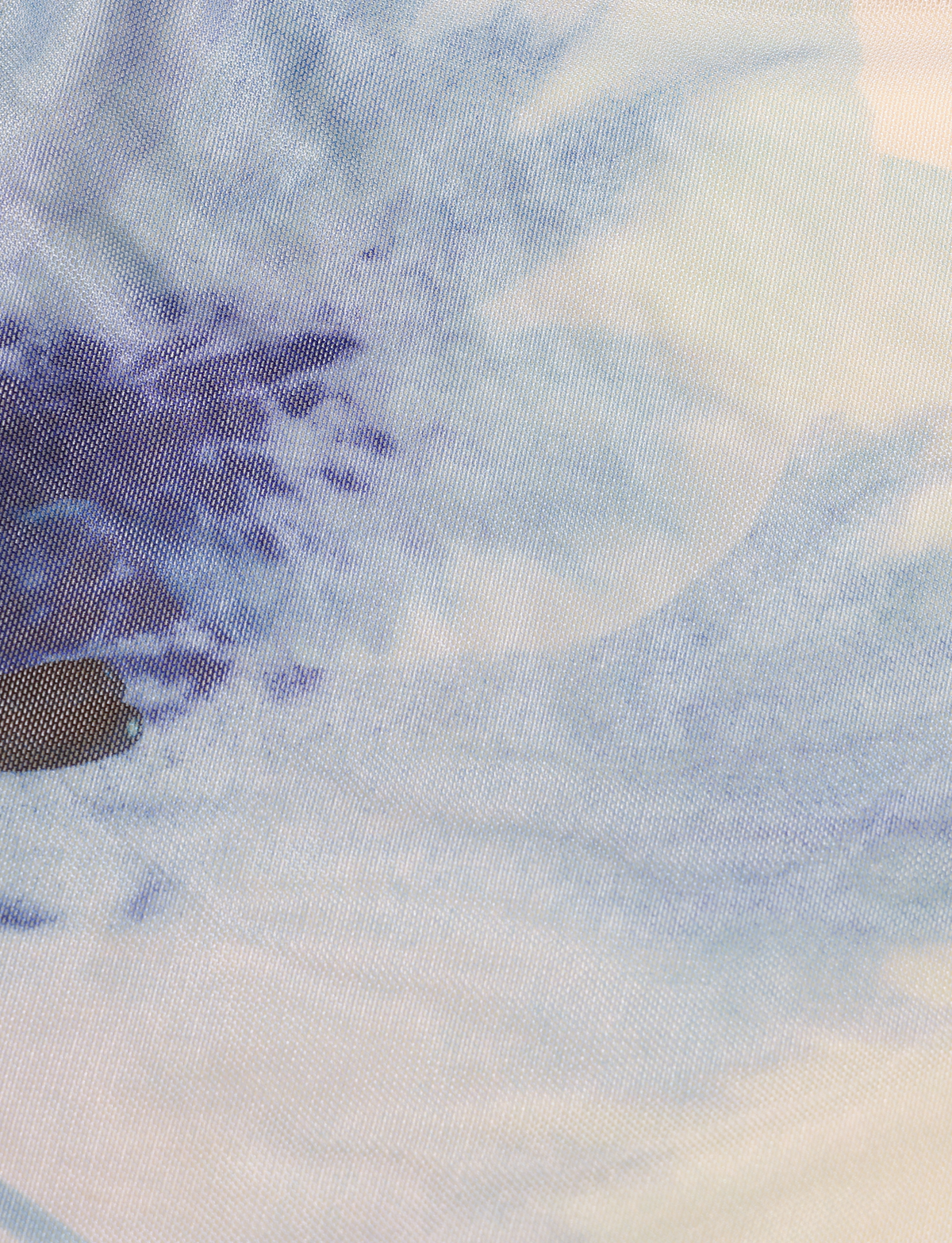 Close-up of the TIGERMIST LILLIAN TOP in white and cream floral, showcasing a soft abstract pattern with visible mesh textile weave.