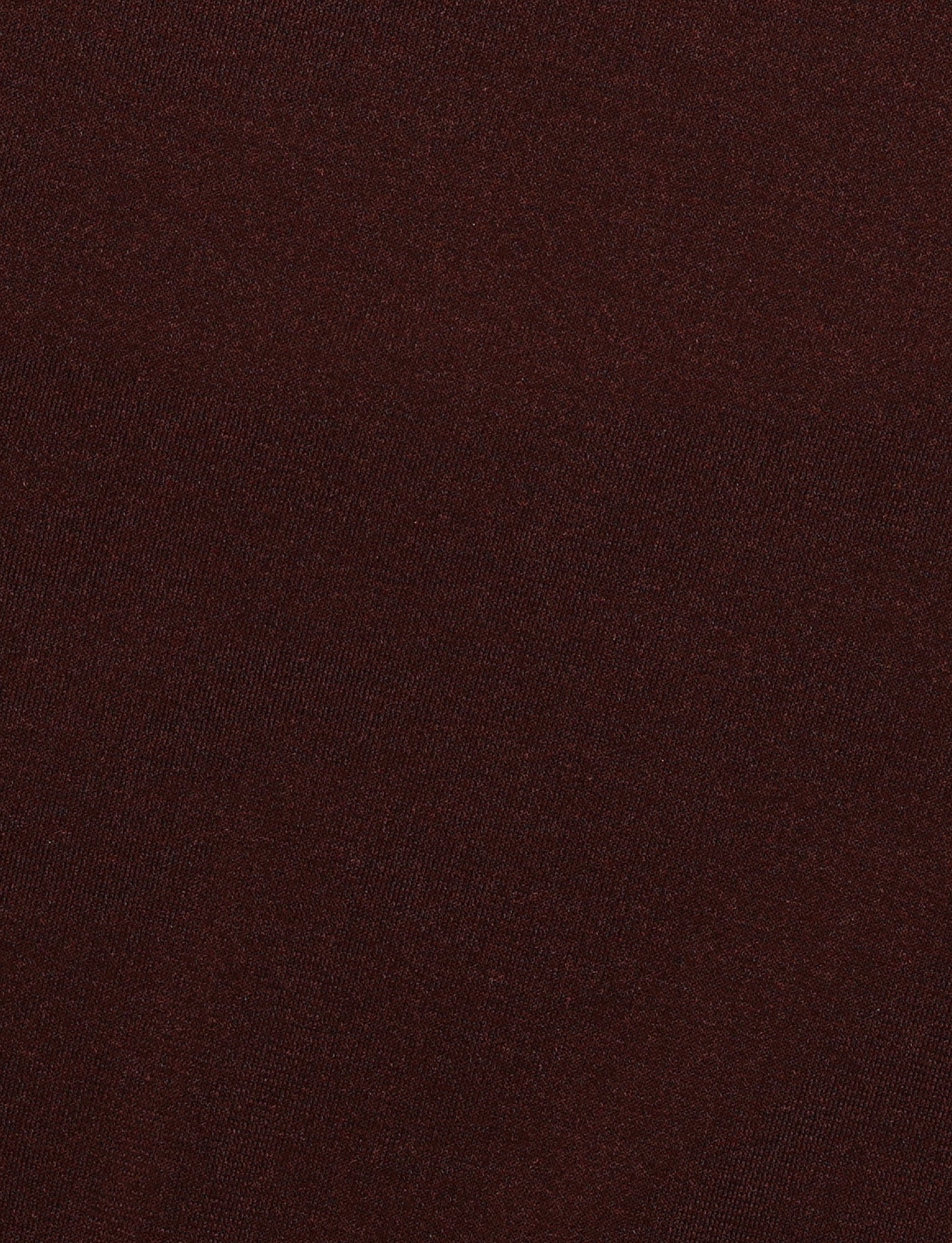 A close-up of the MYLES DRESS - BROWN : CHOCOLATE by TIGERMIST reveals a chocolate brown maxi dress with a slightly textured surface. The fabric looks soft and exhibits subtle tonal variations, contributing to its rich and warm appearance. The tight weave suggests a sturdy and durable high-stretch material, perfect for halter-style designs.