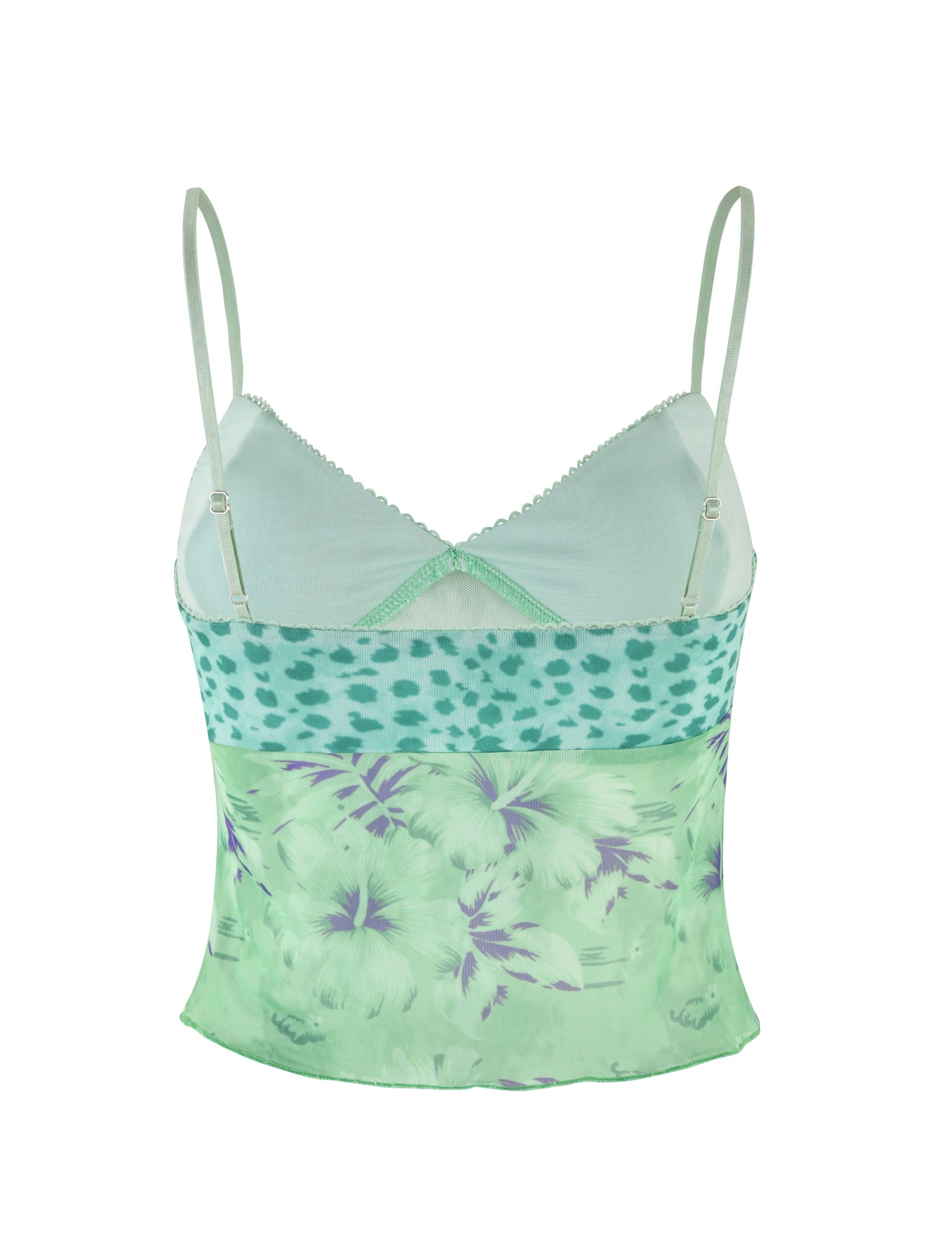 The SAIGE TOP by TIGERMIST is a light green camisole featuring elastic adjustable spaghetti straps and a V-neckline. It boasts intricate details, including a polka dot pattern on the upper section and a floral design on the lower section. The silky fabric combines shades of green and purple, offering an elegant and versatile look.