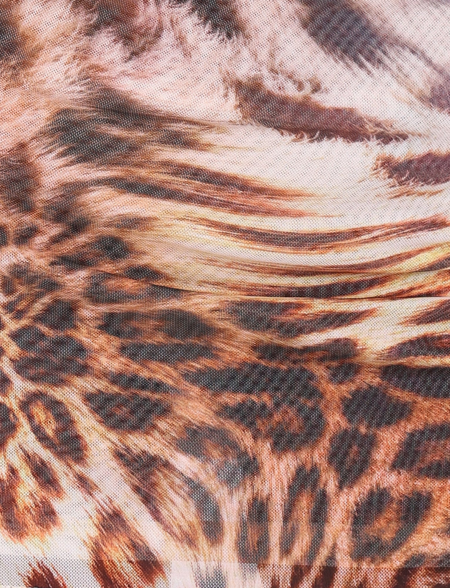 Close-up view of the KALILAH MINI DRESS - NEUTRAL : LEOPARD HAZE by TIGERMIST, showcasing an intricate warped leopard print design. The pattern is reminiscent of leopard spots and fur textures in shades of brown, black, and beige, perfect for a mini dress with adjustable straps.