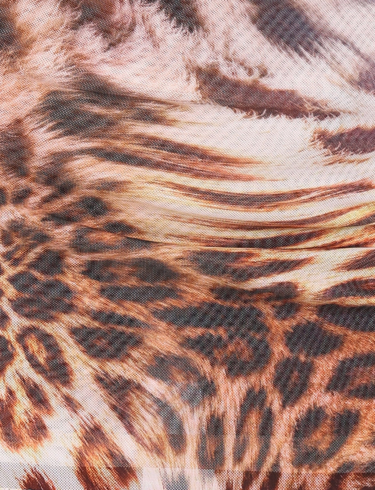 Close-up view of the KALILAH MINI DRESS - NEUTRAL : LEOPARD HAZE by TIGERMIST, showcasing an intricate warped leopard print design. The pattern is reminiscent of leopard spots and fur textures in shades of brown, black, and beige, perfect for a mini dress with adjustable straps.