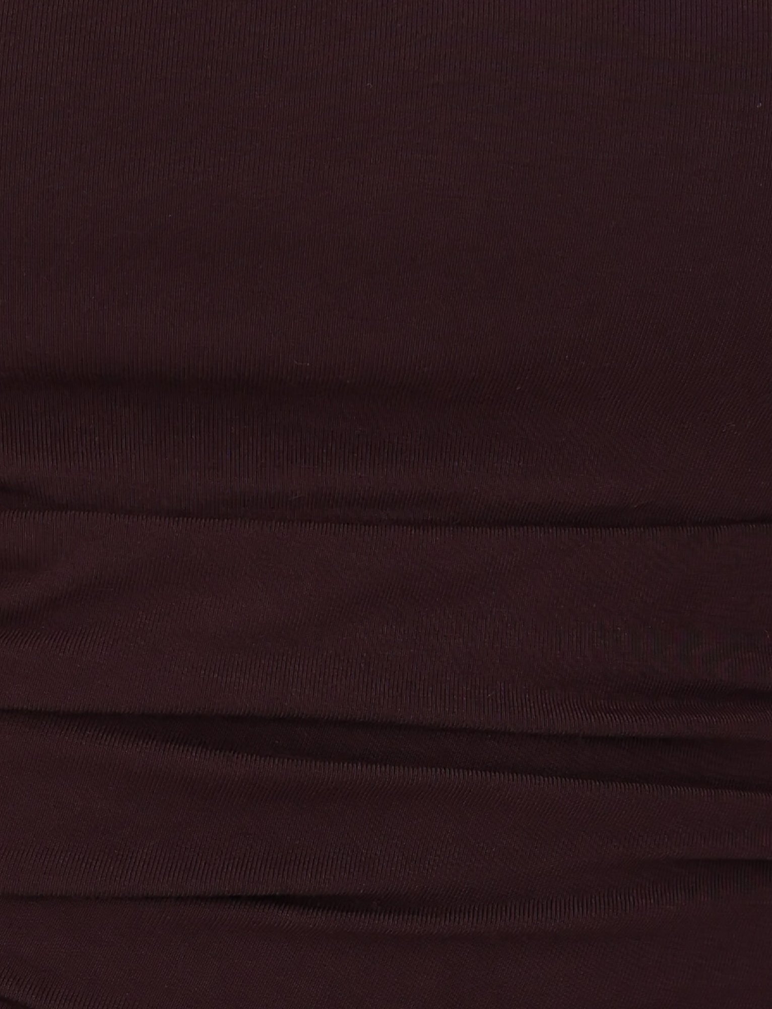 Close-up view of the LEILANI TOP - BROWN : CHOCOLATE by TIGERMIST, featuring dark brown ruched fabric with a buttery jersey texture and horizontal folds.