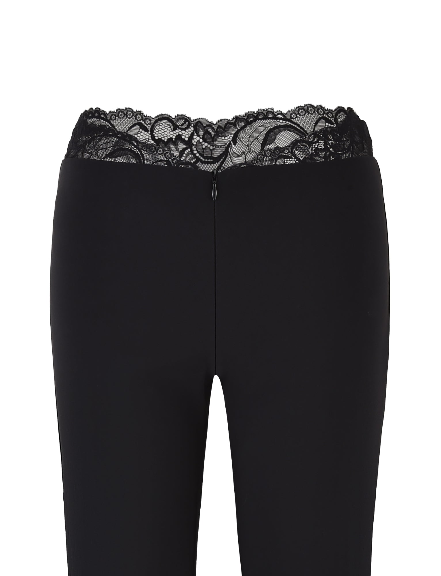 The NYOMI PANT - BLACK by TIGERMIST are black flared leg pants with a high waist and lace trim at the top, made from high stretch fabric and featuring a rear zipper closure.