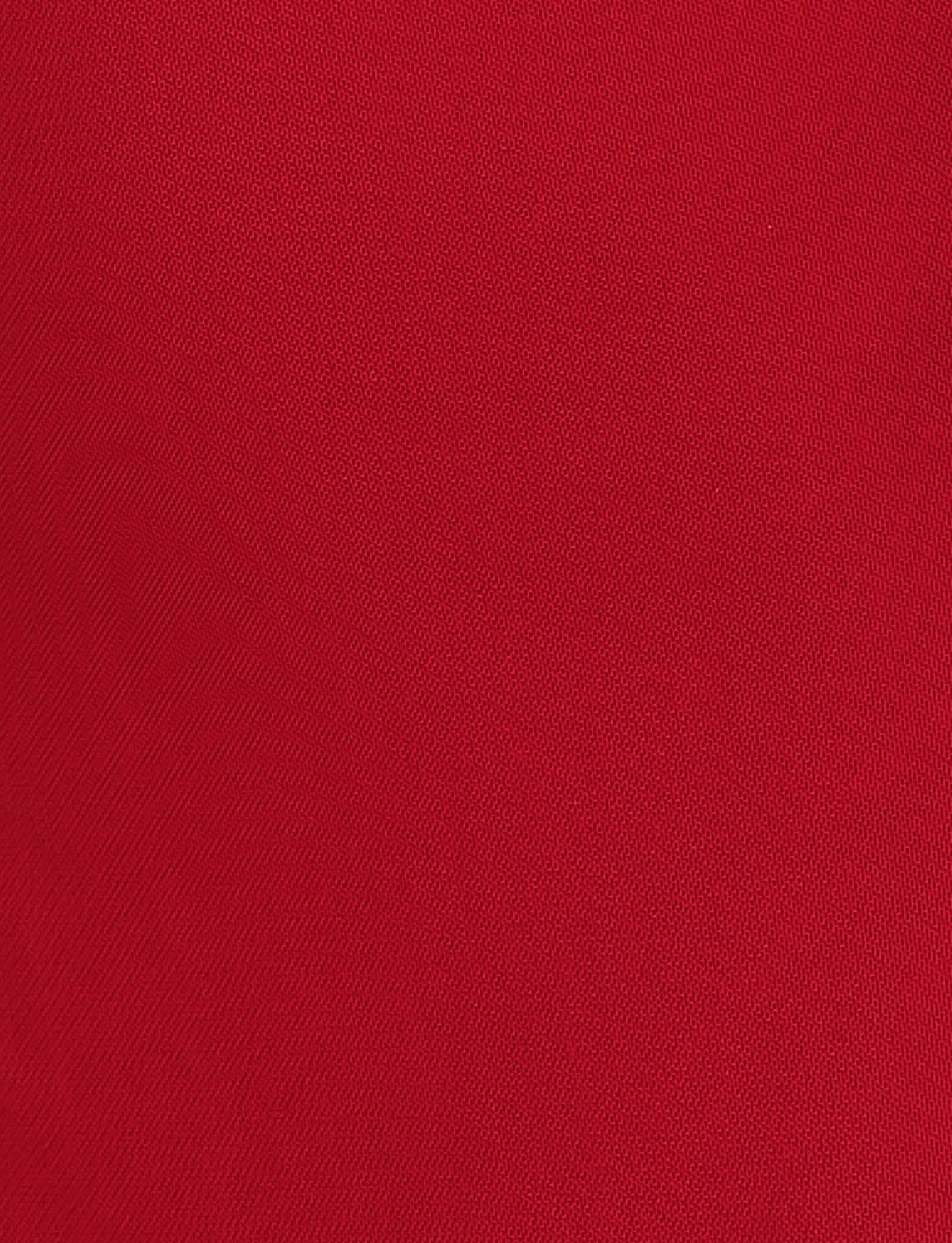 Close-up of the textured red fabric from the TIGERMIST NYOMI MINI DRESS - RED, featuring a fine diagonal weave pattern.