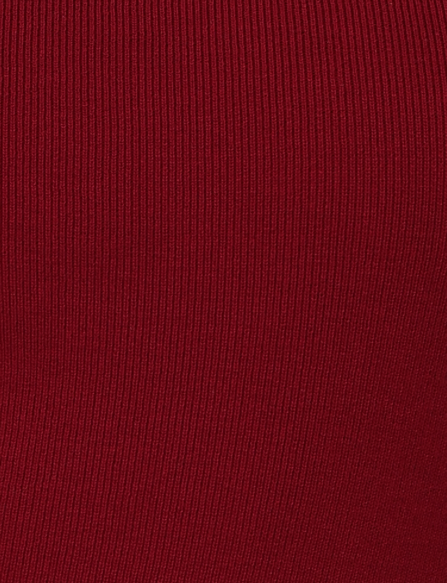 Close-up of red ribbed fabric in the "Wine" colourway, highlighting vertical texture lines from TIGERMIST’s CYPRESS MINI DRESS – RED : WINE.