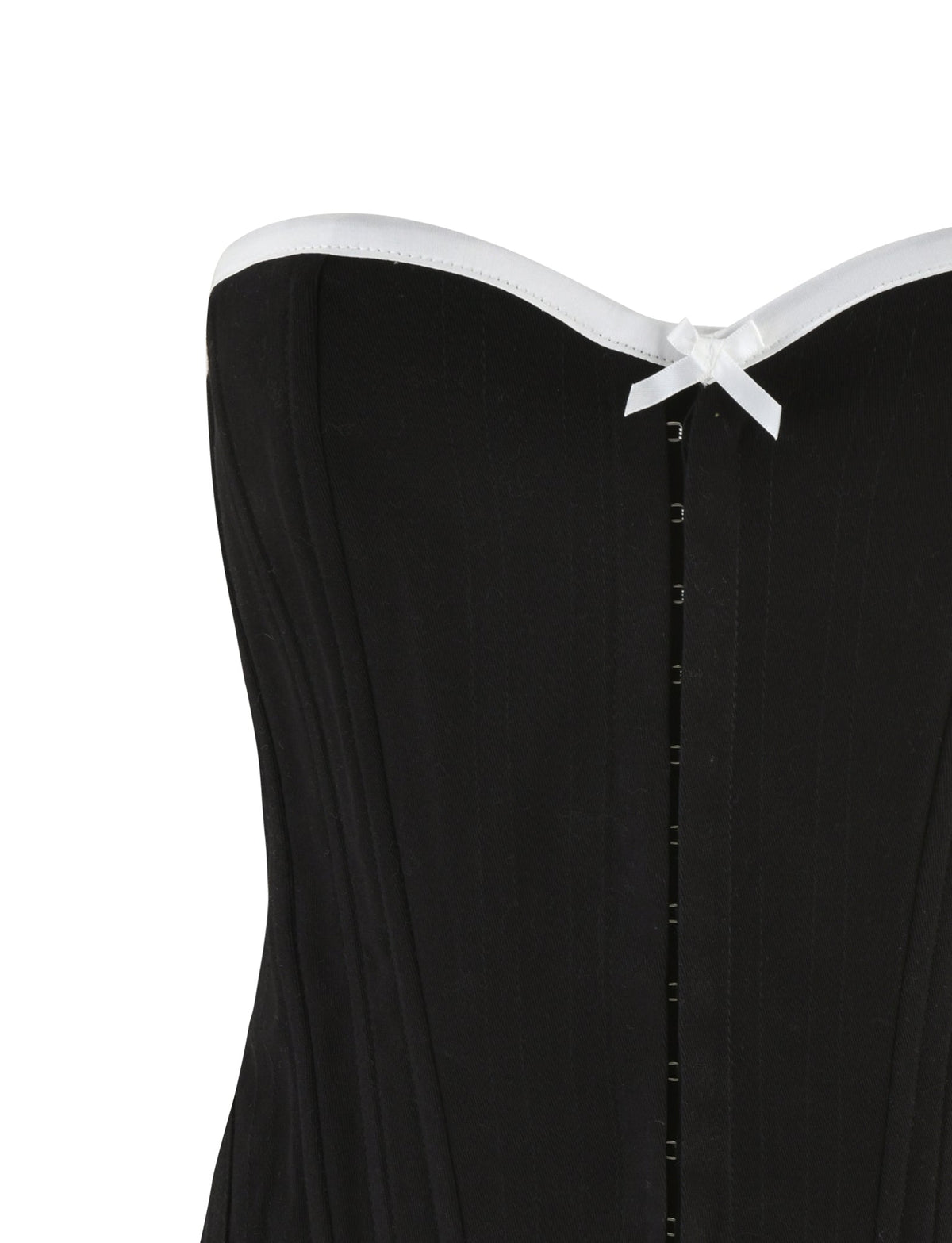 A close-up of the top part of the MILLIE CORSET 2.0 - BLACK by TIGERMIST, featuring a strapless design with white trim along the top edge. The corset includes a small white bow in the center near the top, vertical boning for structure, and a lace-up back for an adjustable fit.