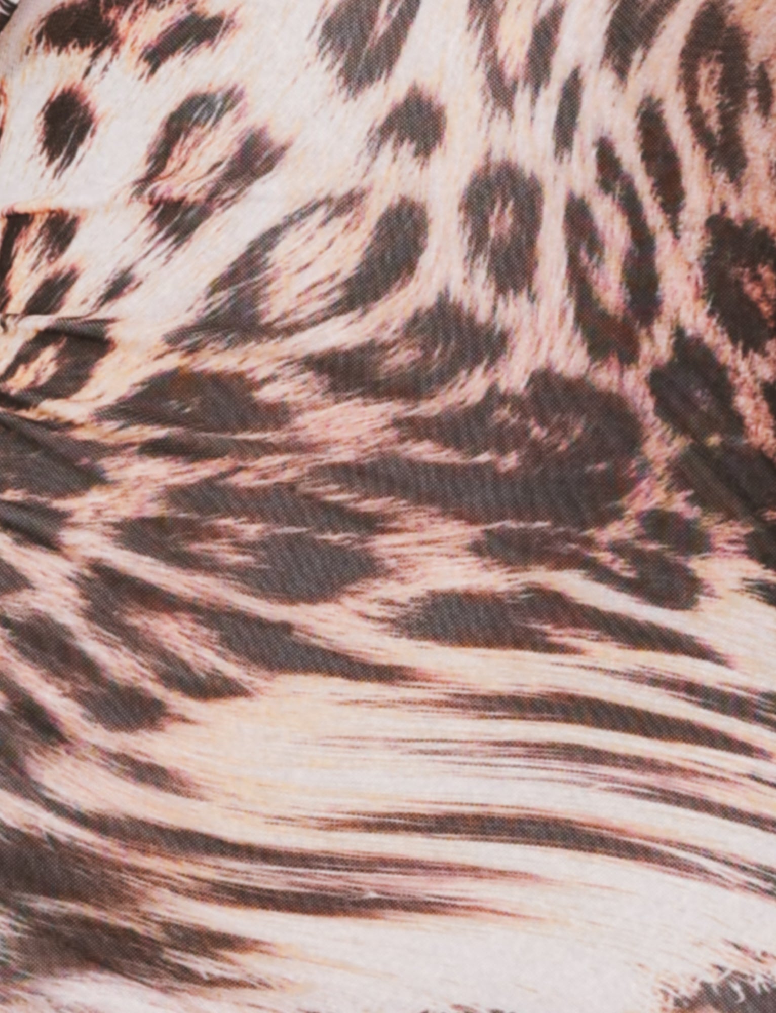 Close-up of the TIGERMIST ALLIRA MESH MINI DRESS 2.0 in the Leopard Haze design, featuring an animal print pattern reminiscent of leopard spots in shades of brown, black, and beige. The texture appears soft, emphasizing the intricate design of this striking dress.