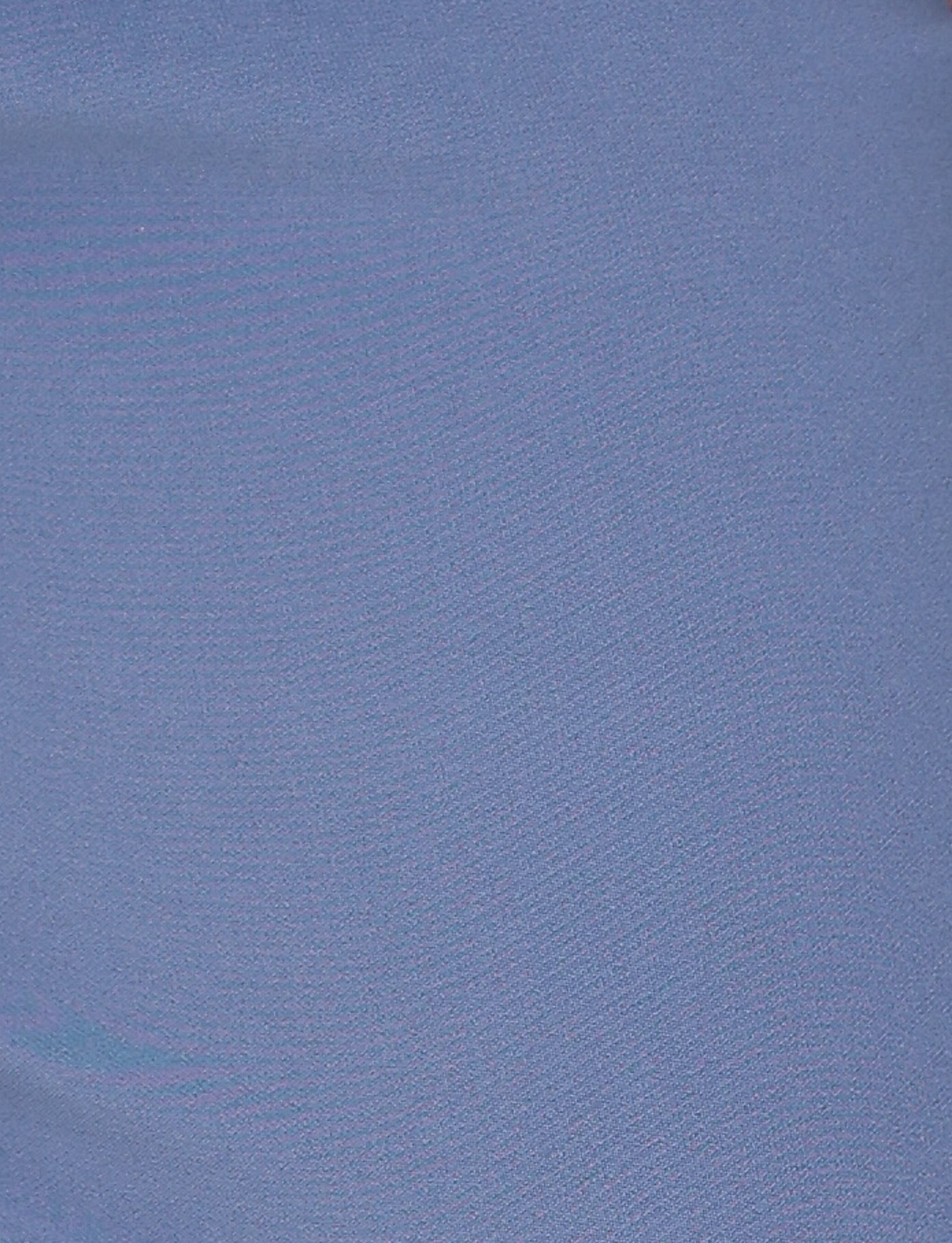 A detailed view of the smooth fabric from the KITTIE PANT - BLUE: STEEL BLUE by TIGERMIST reveals a subtle shine, indicating a soft and silky texture. The solid steel blue hue exudes understated elegance reminiscent of low-rise waist designs or flare fits, with the image concentrating on the alluring texture and color of the material.