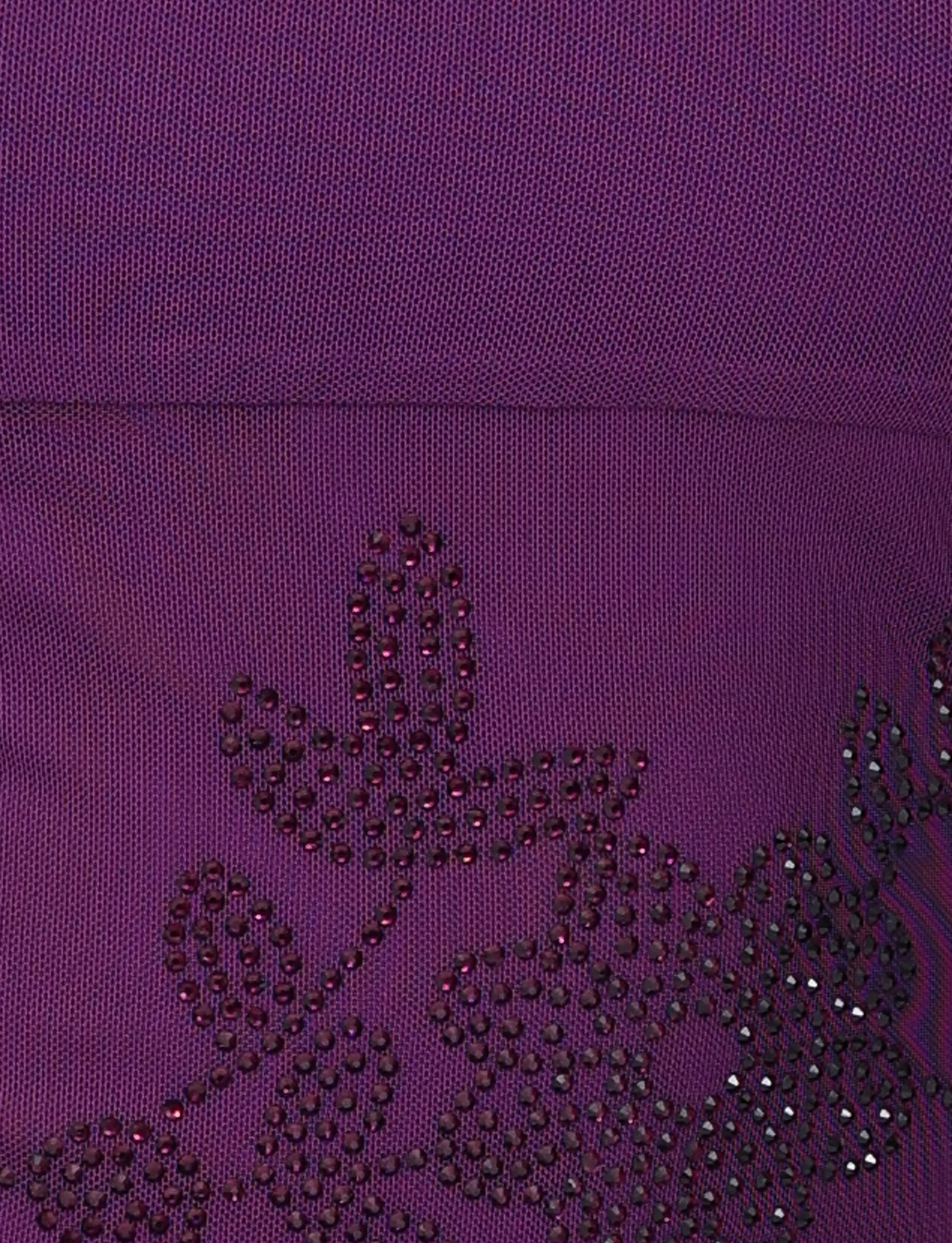 Close-up of purple fabric with beaded floral embellishments. Dark beads form outlines of flowers and leaves on the textured material, adding elegance to the TIGERMIST OCTAVIA TOP - PURPLE.
