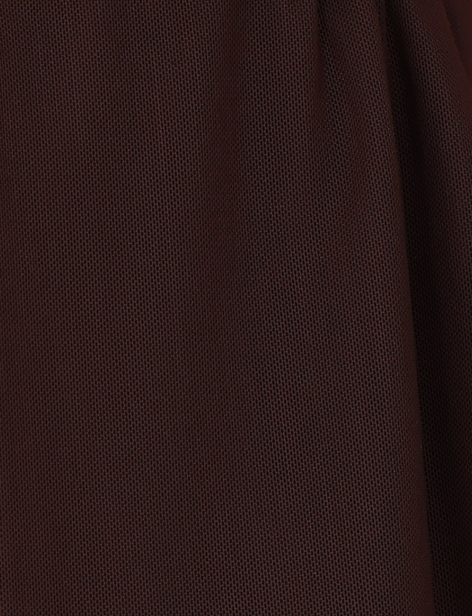 Close-up of the TIGERMIST ESHA TOP - BROWN : CHOCOLATE, showing dark brown mesh fabric with small, evenly spaced holes, slightly gathered on the right—reminiscent of stylish halter neck material.