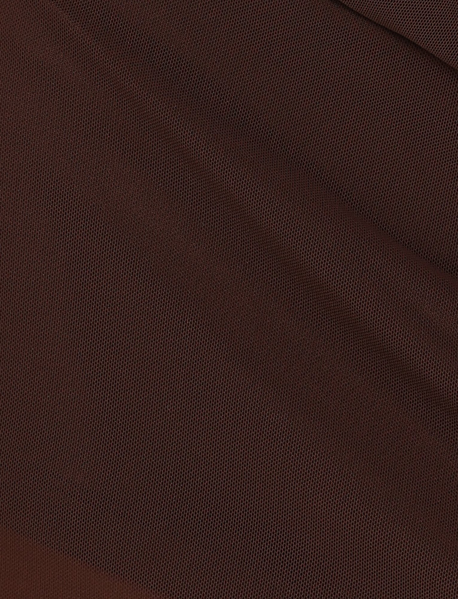 Close-up of the TIGERMIST OCTAVIA MINI SKIRT - BROWN : CHOCOLATE, showcasing chocolate mesh fabric with fine dots and diagonal folds for a subtle pattern and movement in its high-stretch material.